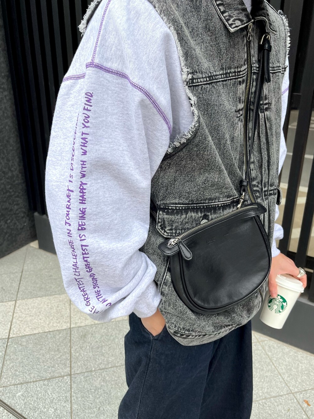 グレー系のスウェット、ブラック系のベスト、ブルー系のデニムパンツを着用したメンズの冬コーディネートの3枚目の写真