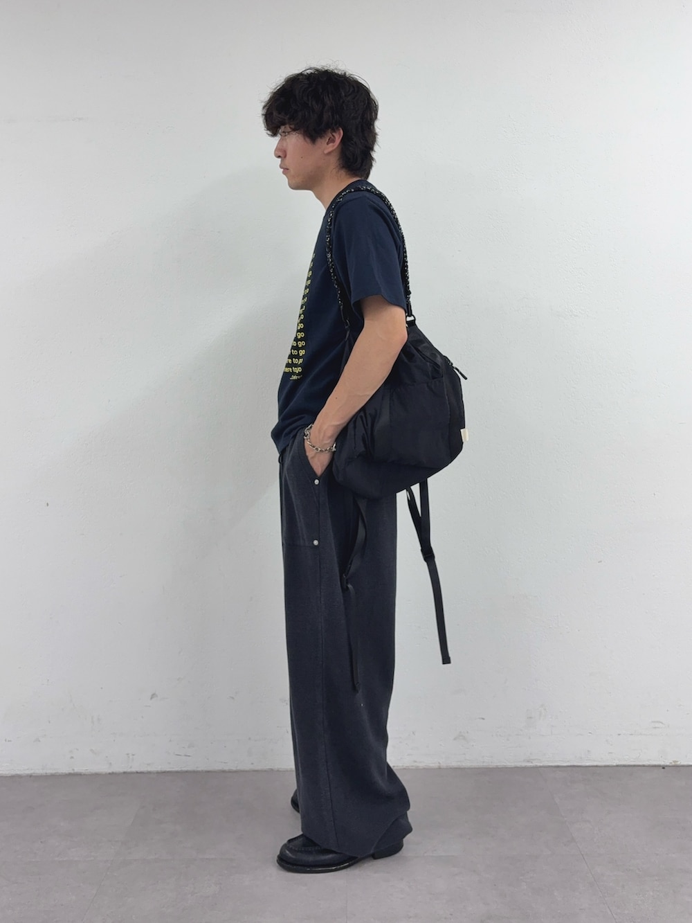 ブルー系のTシャツ/カットソー、ブラック系のトートバッグ、ブラック系のスウェットパンツを着用したメンズの春コーディネートの2枚目の写真