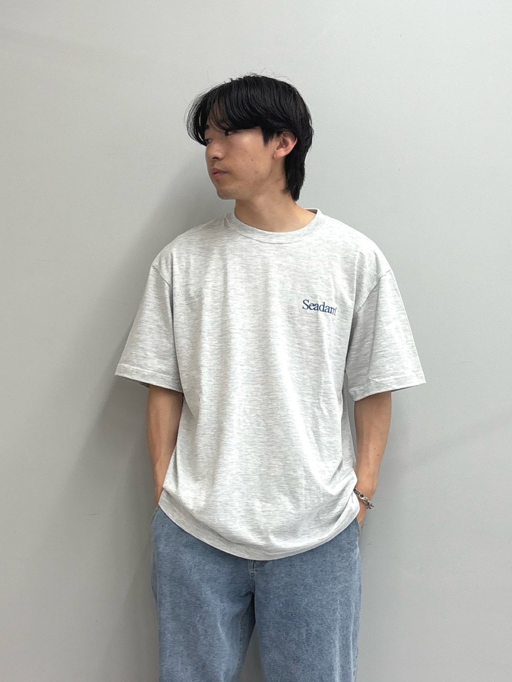 ブラック系のナイロンジャケット、グレー系のTシャツ/カットソー、ブルー系のデニムパンツを着用したメンズの春コーディネートの3枚目の写真