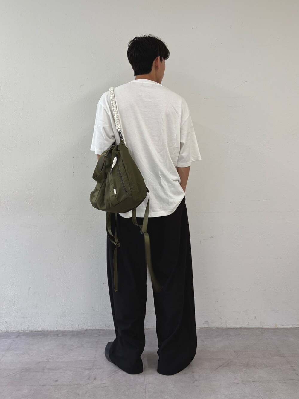 ホワイト系のTシャツ/カットソー、ブラック系のスラックスを着用したメンズの秋コーディネートの3枚目の写真