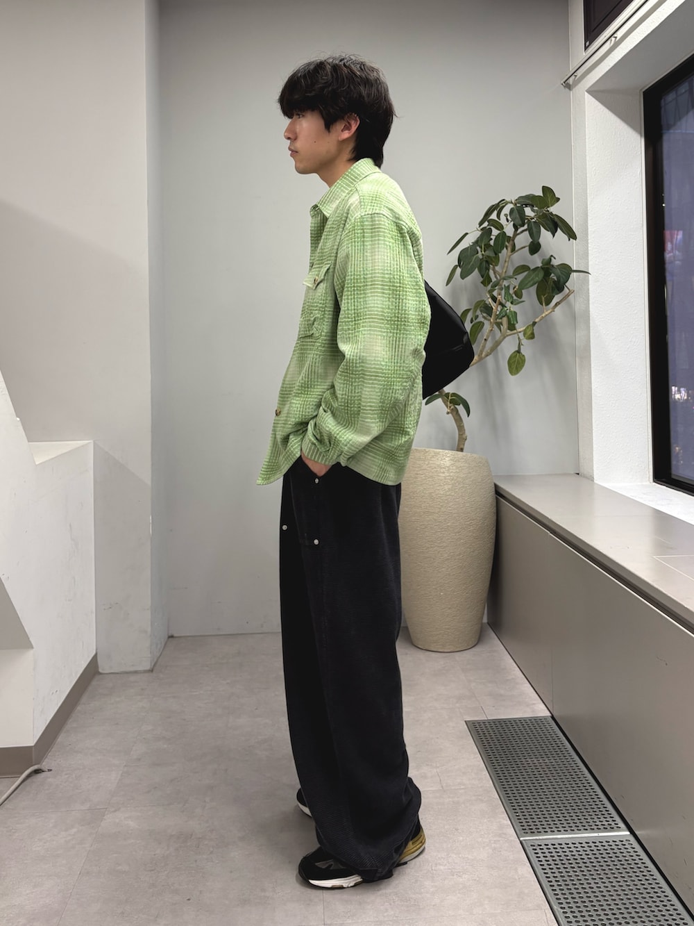 グリーン系のシャツ/ブラウス、ブラック系のショルダーバッグ、ブラック系のスウェットパンツを着用したメンズの春コーディネートの2枚目の写真