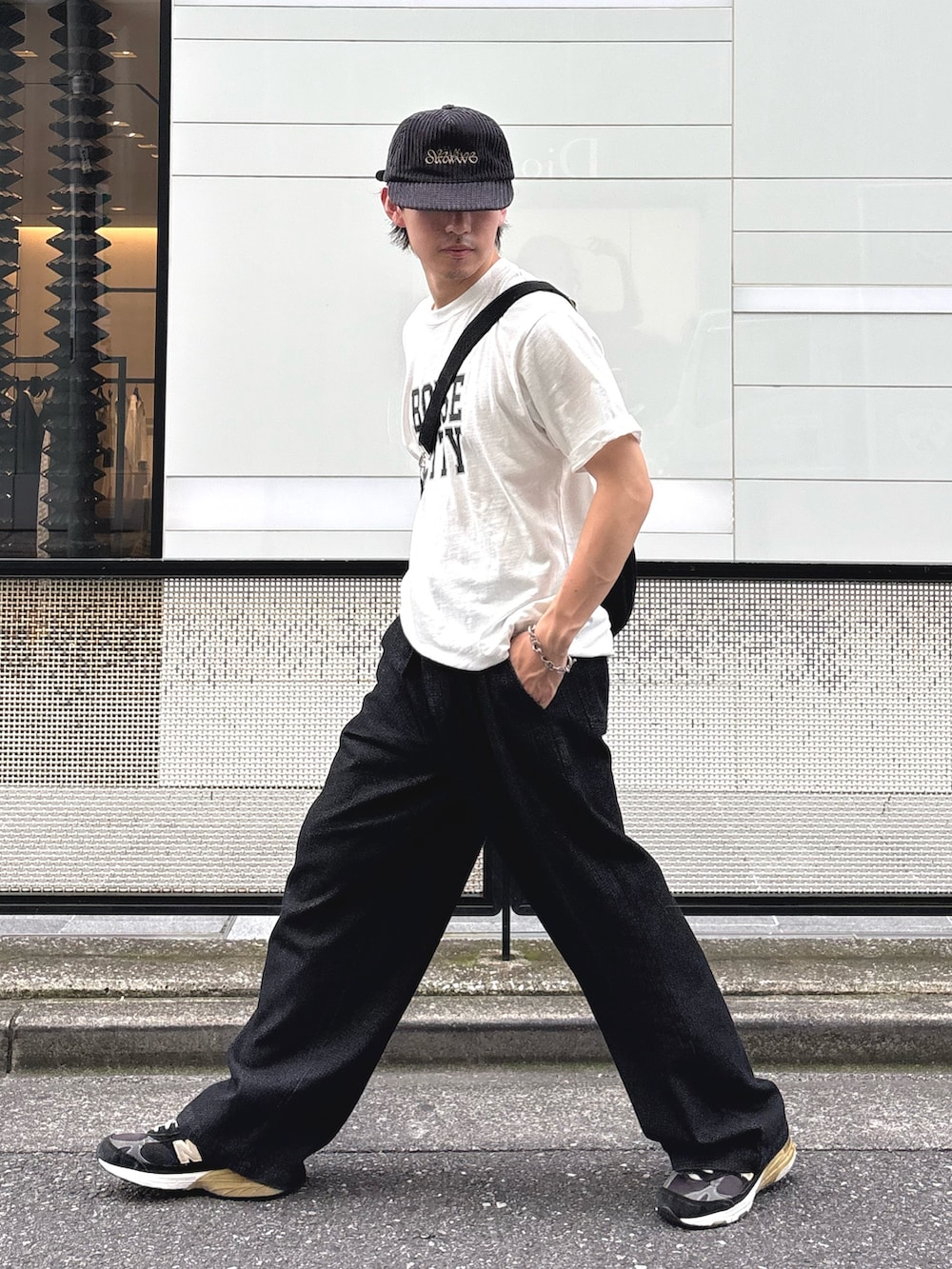 ホワイト系のTシャツ/カットソー、ブラック系のスラックスを着用したメンズの夏コーディネートの2枚目の写真