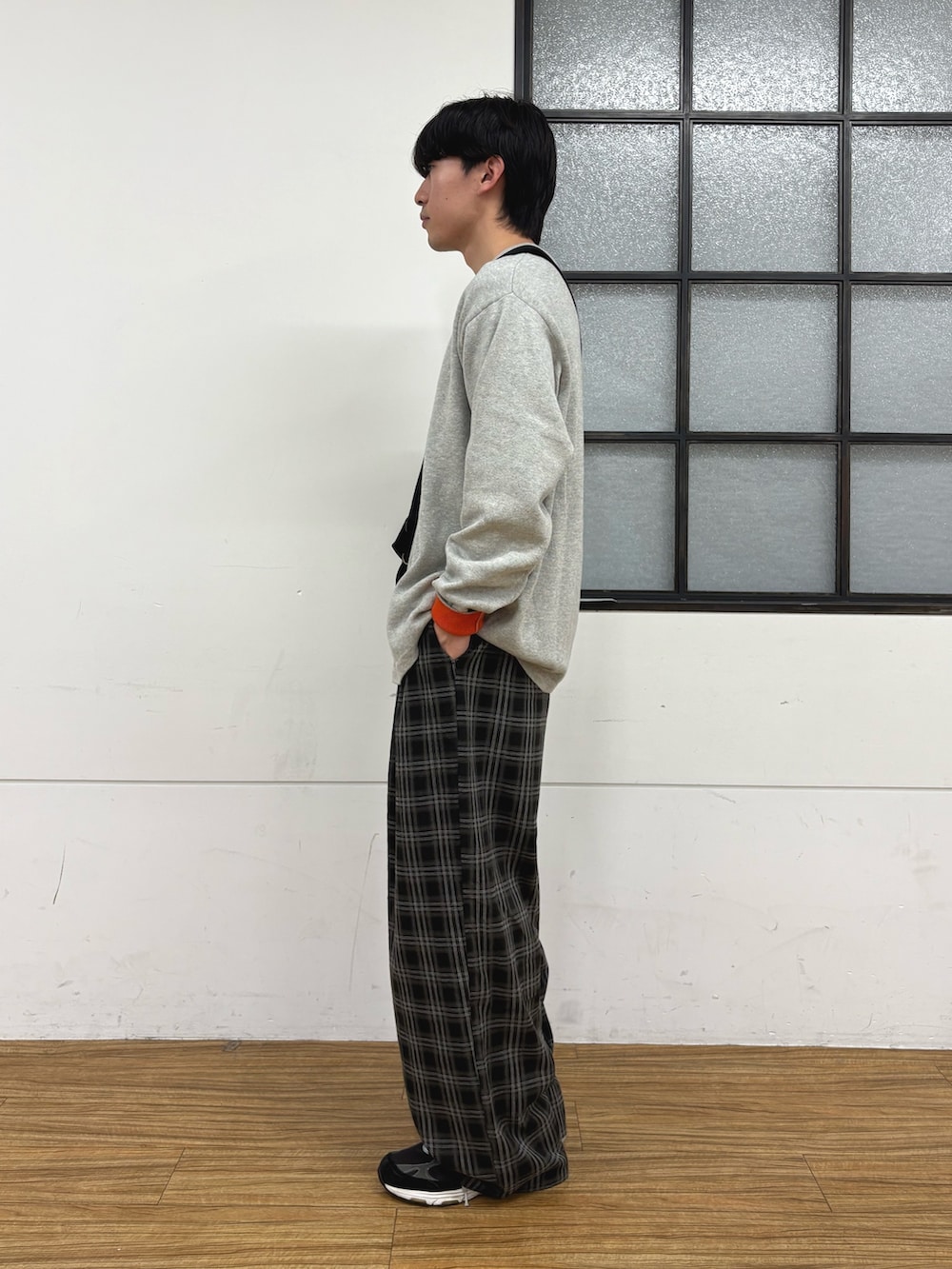グレー系のニット/セーター、ブラック系のショルダーバッグ、ブラック系のその他パンツを着用したメンズの冬コーディネートの2枚目の写真