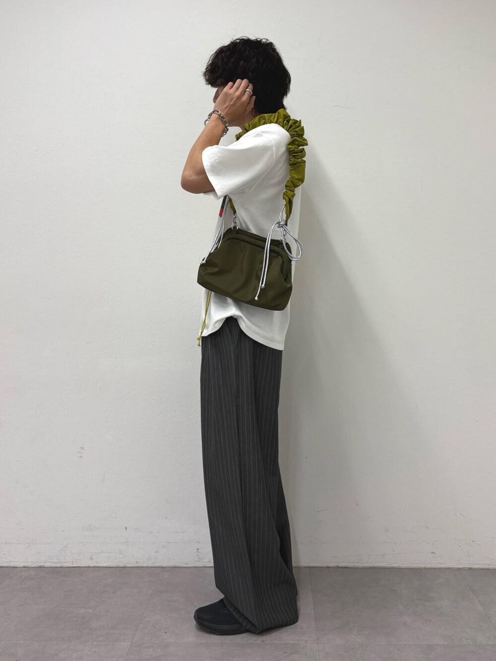 ホワイト系のTシャツ/カットソー、グレー系のスラックスを着用したメンズの夏コーディネートの2枚目の写真