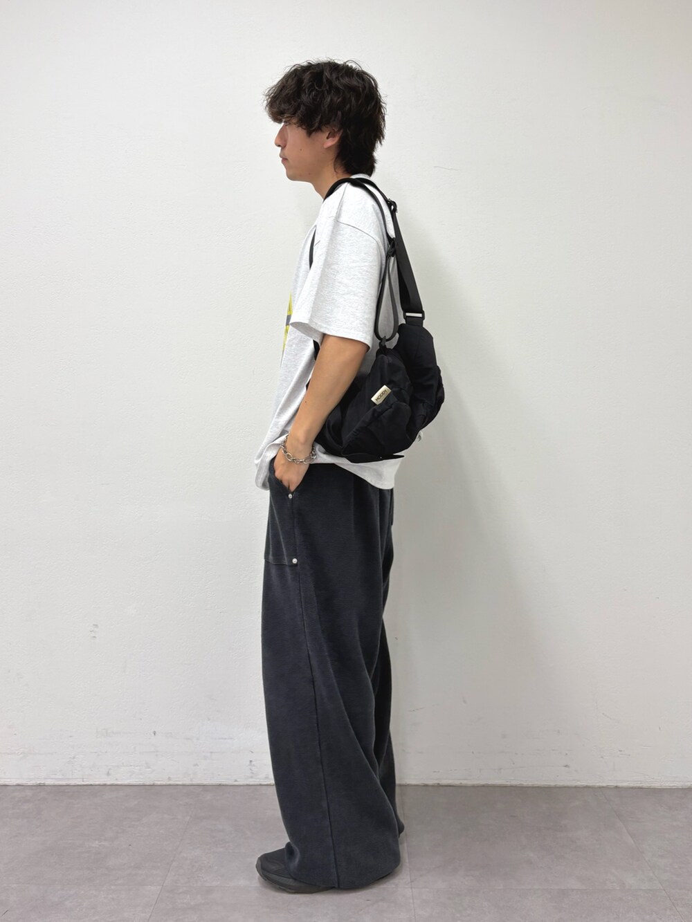 グレー系のTシャツ/カットソー、ブラック系のバックパック/リュック、ブラック系のスウェットパンツを着用したメンズの夏コーディネートの2枚目の写真
