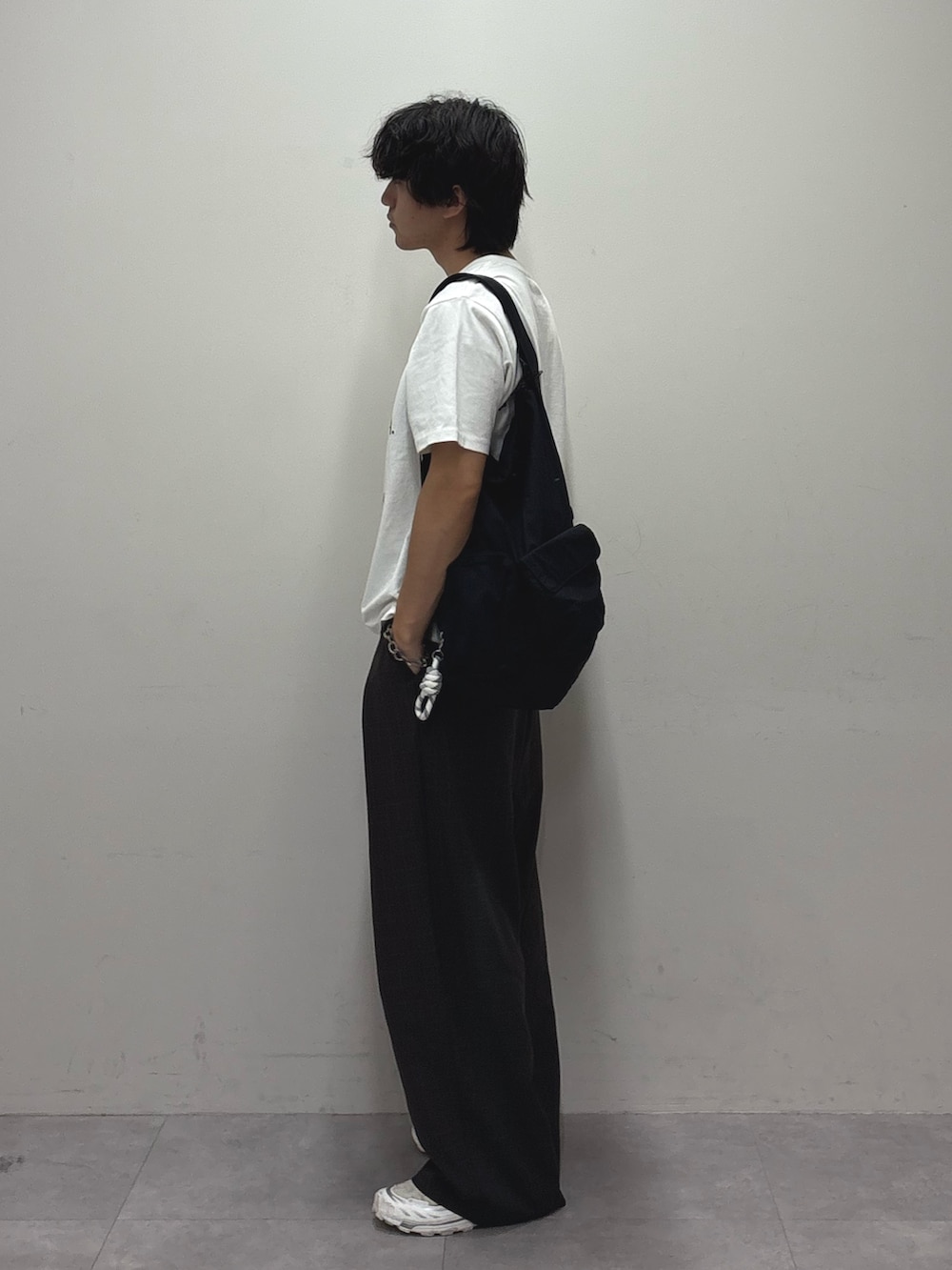 ホワイト系のTシャツ/カットソー、グレー系のスラックス、ブラック系のバックパック/リュックを着用したメンズの夏コーディネートの2枚目の写真