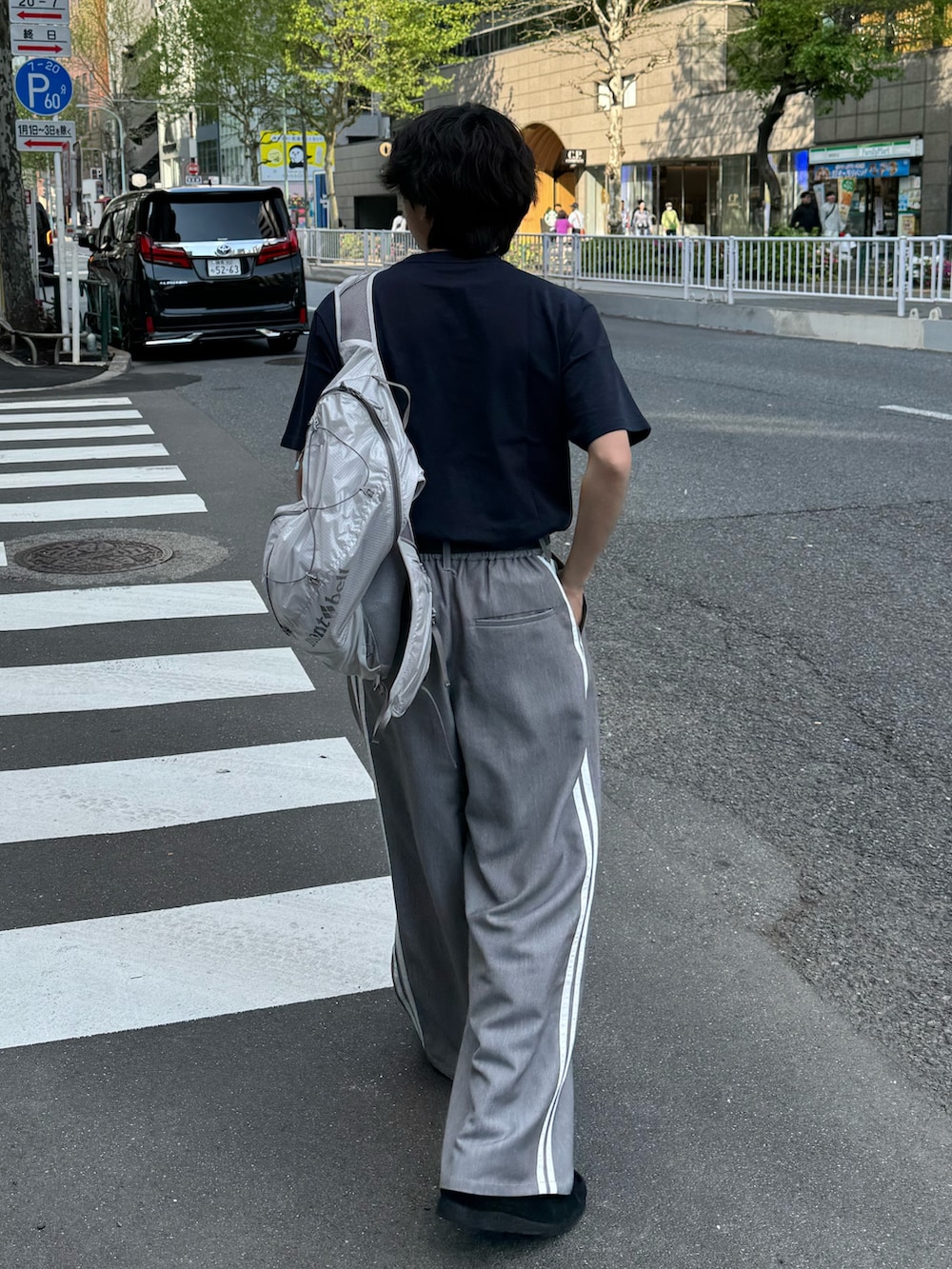 ブルー系のTシャツ/カットソー、グレー系のスラックスを着用したメンズの春コーディネートの2枚目の写真