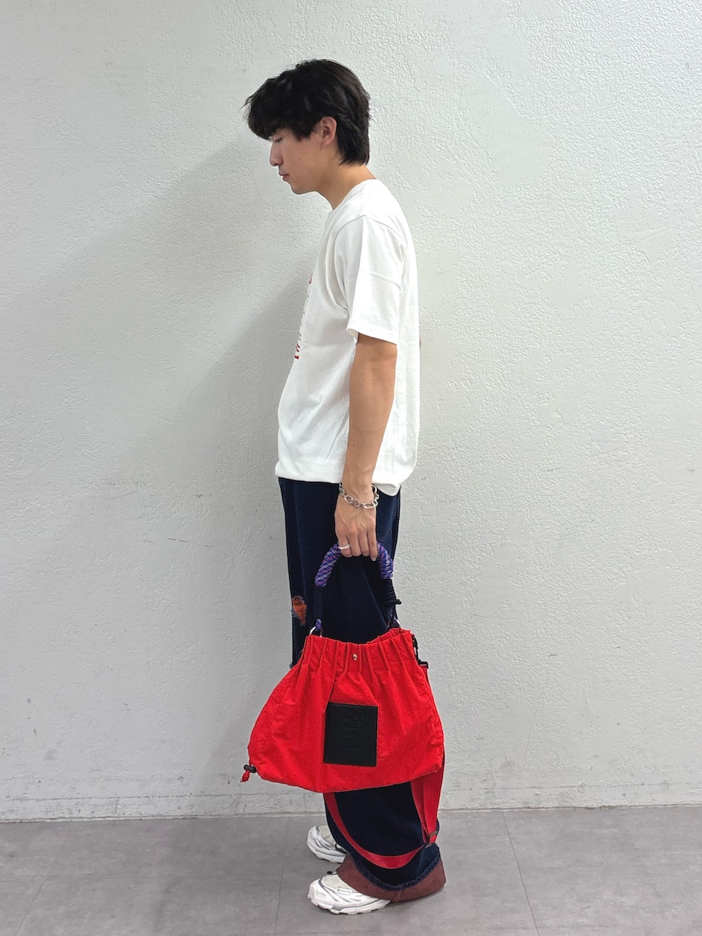ホワイト系のTシャツ/カットソー、オレンジ系のデニムパンツ、レッド系のトートバッグを着用したメンズの夏コーディネートの2枚目の写真