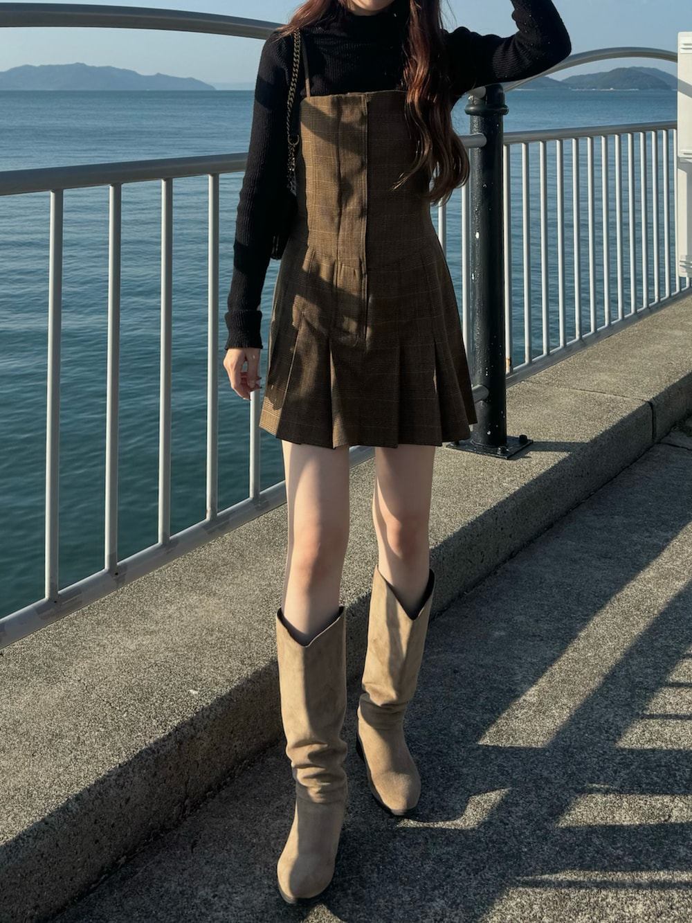 その他のワンピース、ベージュ系のブーツ、ブラック系のショルダーバッグを着用したレディースの秋コーディネートの2枚目の写真