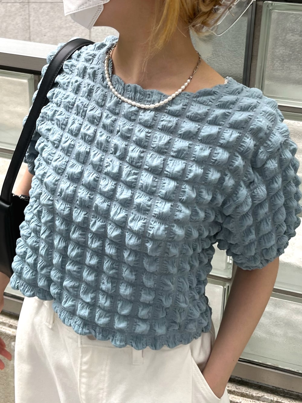 グリーン系のTシャツ/カットソー、ホワイト系のパンツ、ブラック系のシューズを着用したレディースの夏コーディネートの2枚目の写真