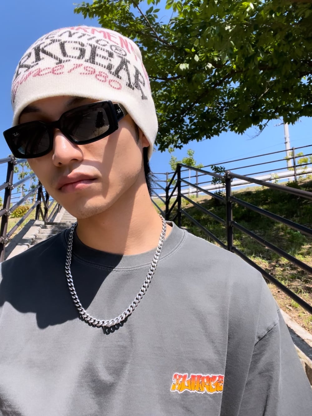 ブラック系のTシャツ/カットソー、グリーン系のカーゴパンツ、ブラック系のスニーカーを着用したメンズの春コーディネートの2枚目の写真