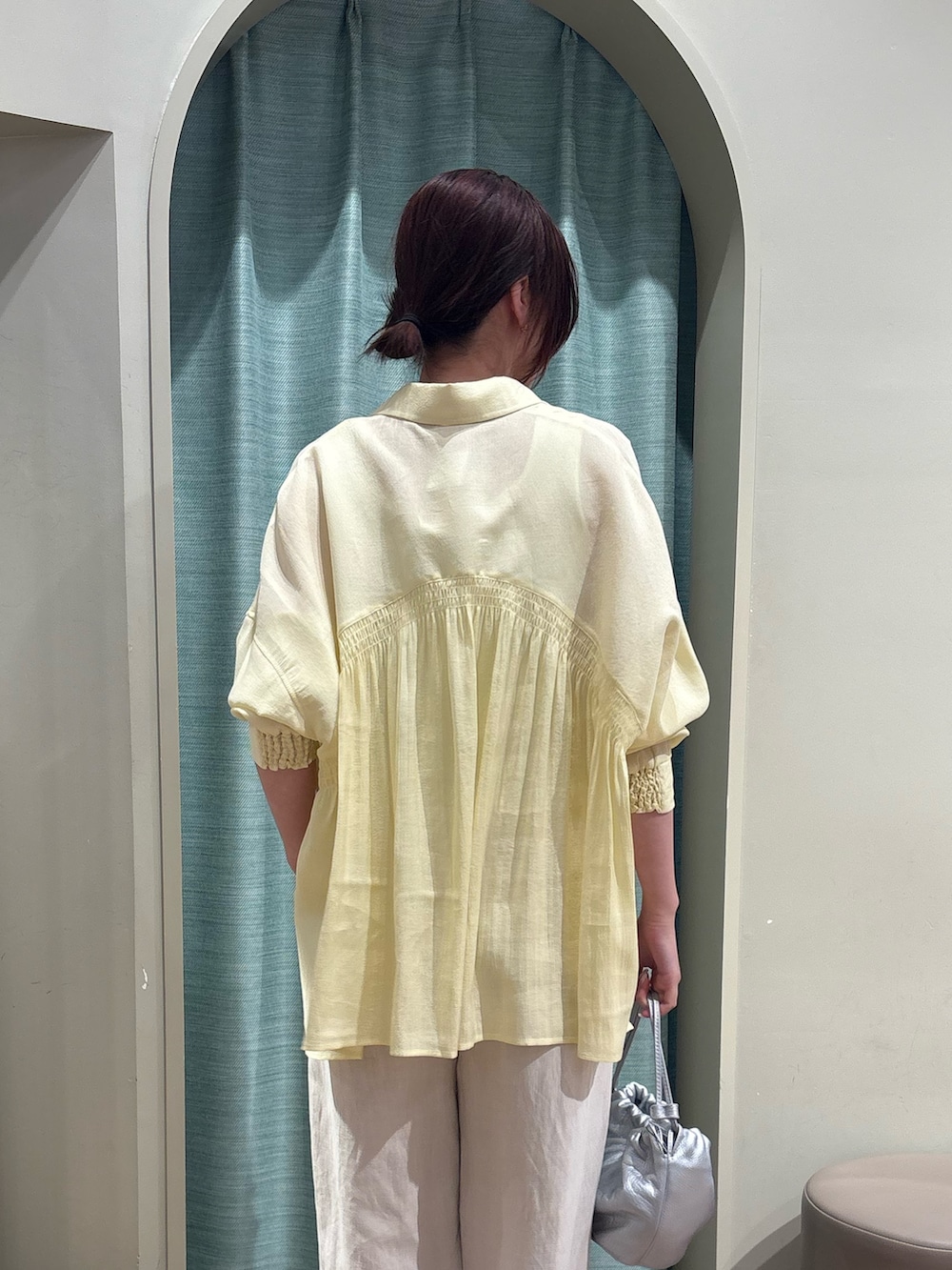 ホワイト系のキャミソール、イエロー系のシャツ/ブラウス、ベージュ系のその他パンツを着用したレディースの春コーディネートの2枚目の写真