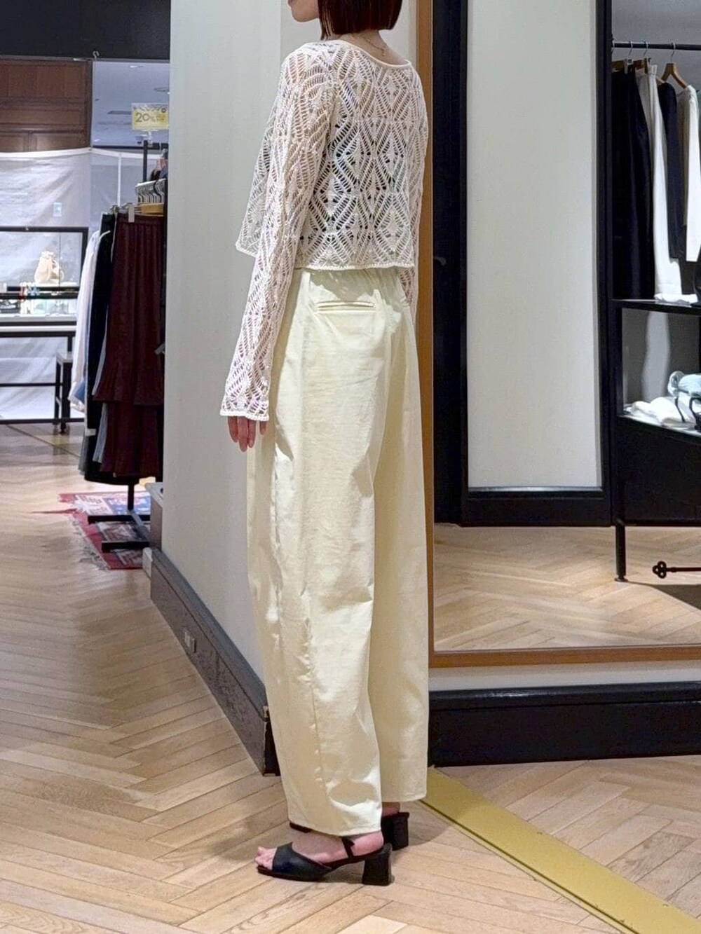 ホワイト系のショルダーバッグ、ホワイト系のカーディガン/ボレロ、ブラック系のサンダルを着用したレディースの春コーディネートの4枚目の写真