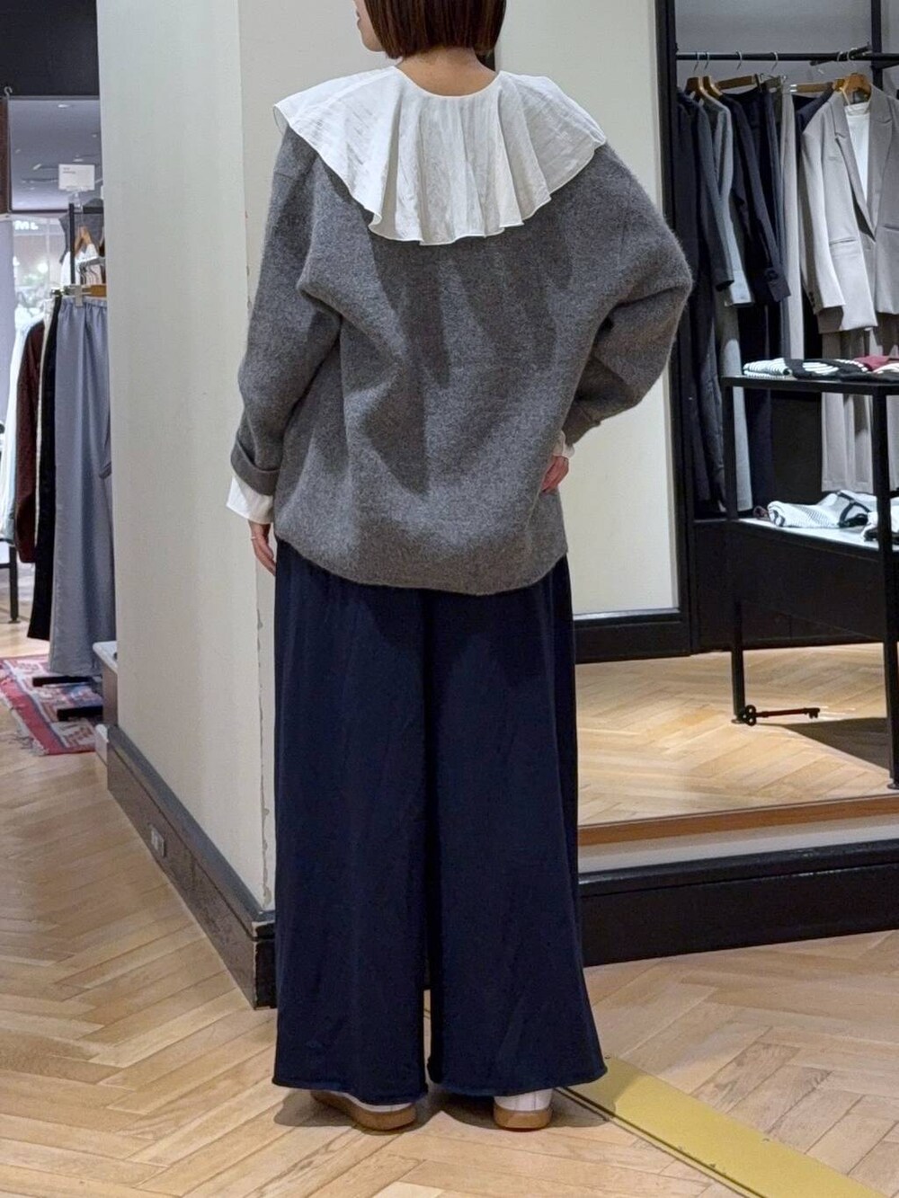 グレー系のカーディガン/ボレロ、ホワイト系のシャツ/ブラウス、ブルー系のスウェットパンツを着用したレディースの秋コーディネートの4枚目の写真