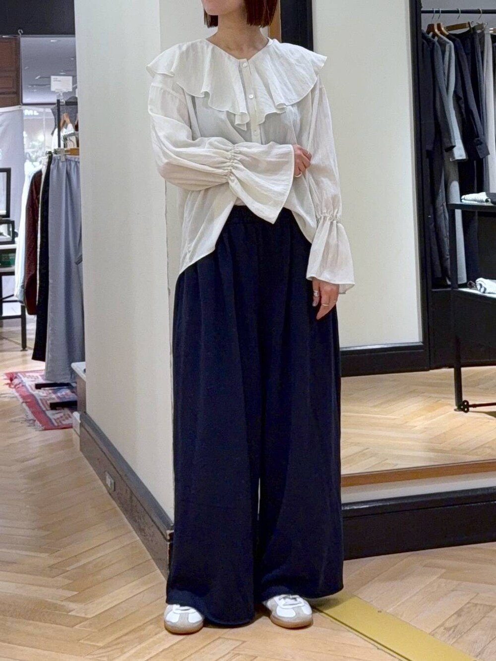 グレー系のカーディガン/ボレロ、ホワイト系のシャツ/ブラウス、ブルー系のスウェットパンツを着用したレディースの秋コーディネートの7枚目の写真