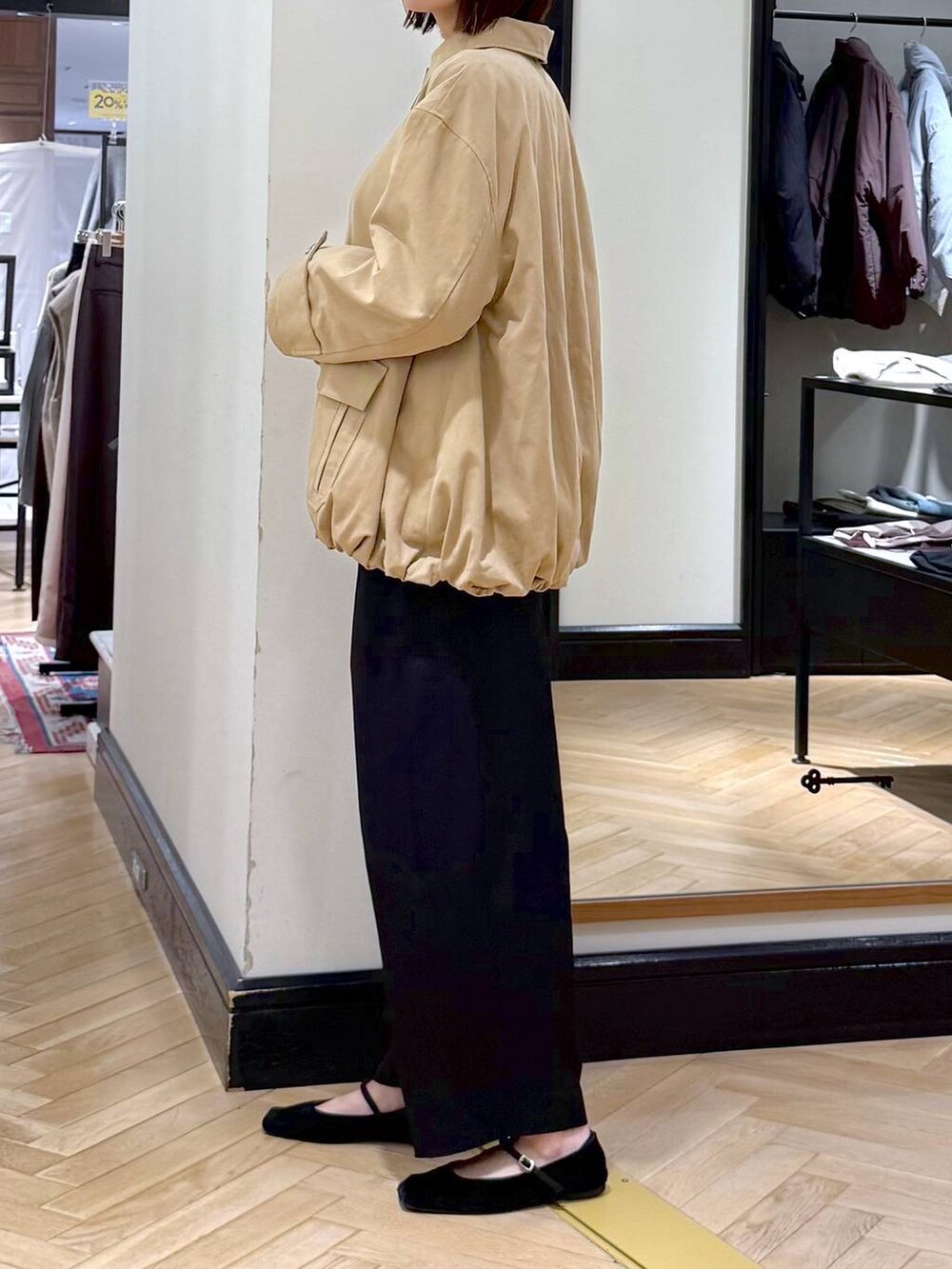 ブラック系のスラックス、グレー系のニット/セーター、ブラック系のショルダーバッグを着用したレディースの秋コーディネートの3枚目の写真