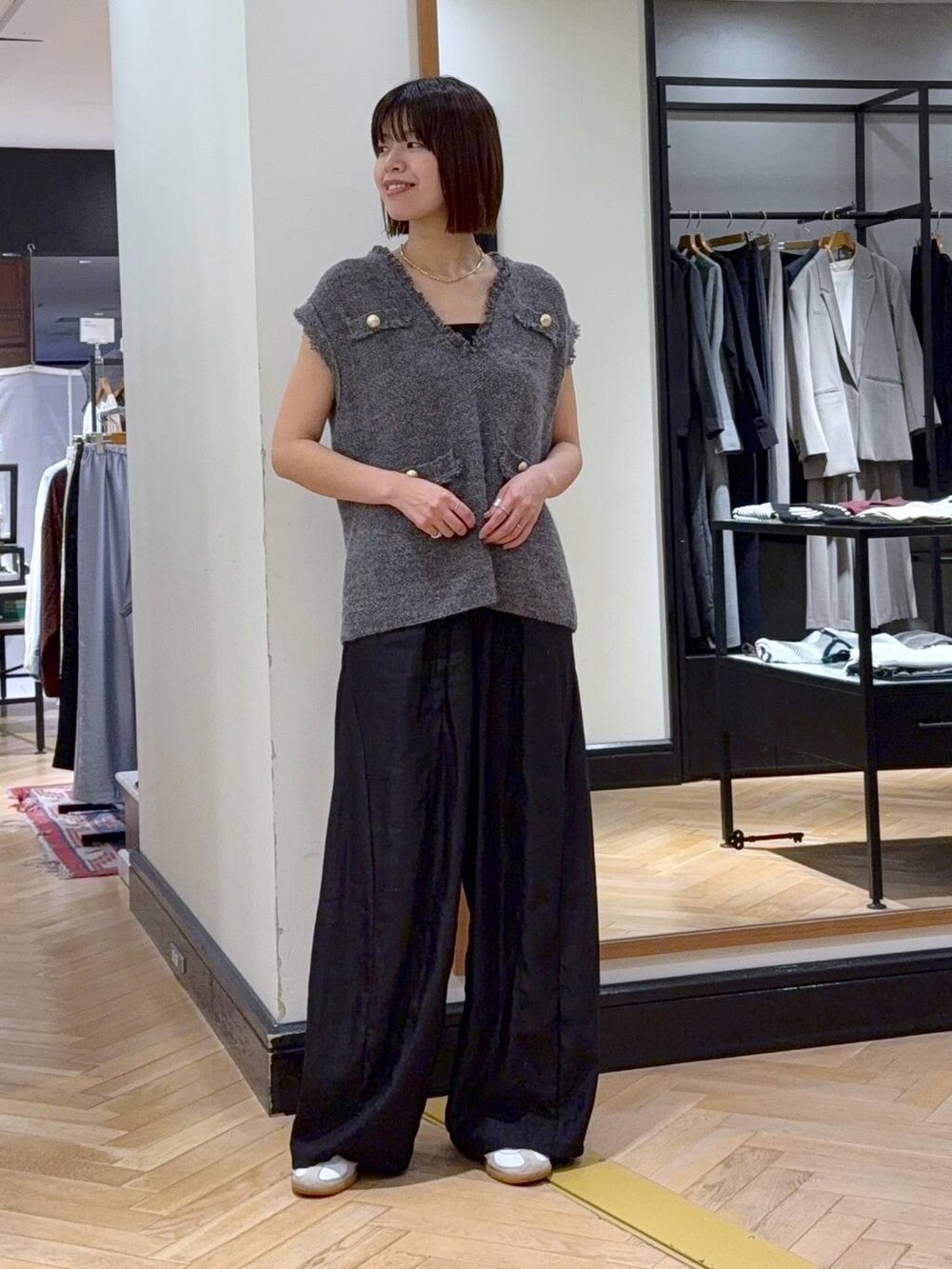 グレー系のベスト、ブラック系のその他パンツ、ブラック系のショルダーバッグを着用したレディースの秋コーディネートの5枚目の写真