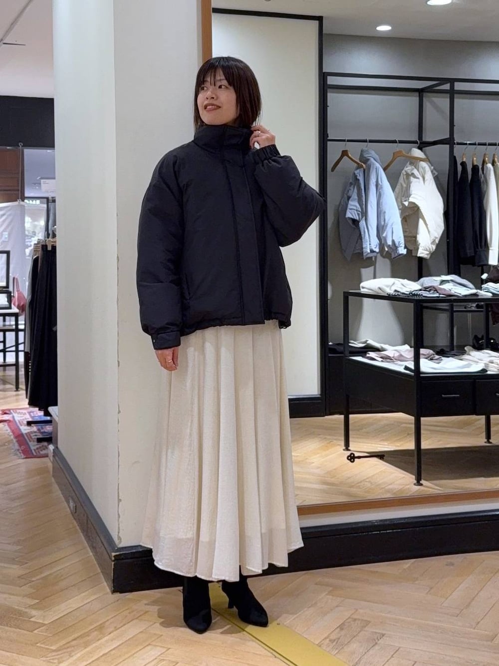 ブラウン系のニット/セーター、ブラック系のブルゾン、ブラック系のブーツを着用したレディースの秋コーディネートの2枚目の写真