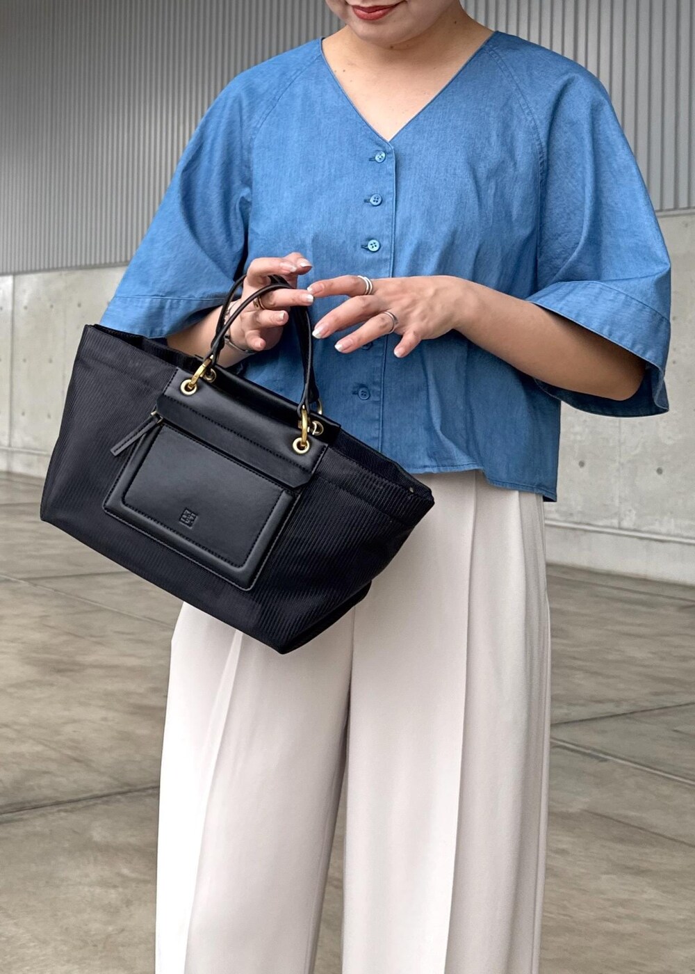 ベージュ系のその他パンツ、ブラック系のハンドバッグ、シルバー系のサンダルを着用したレディースの春コーディネートの5枚目の写真