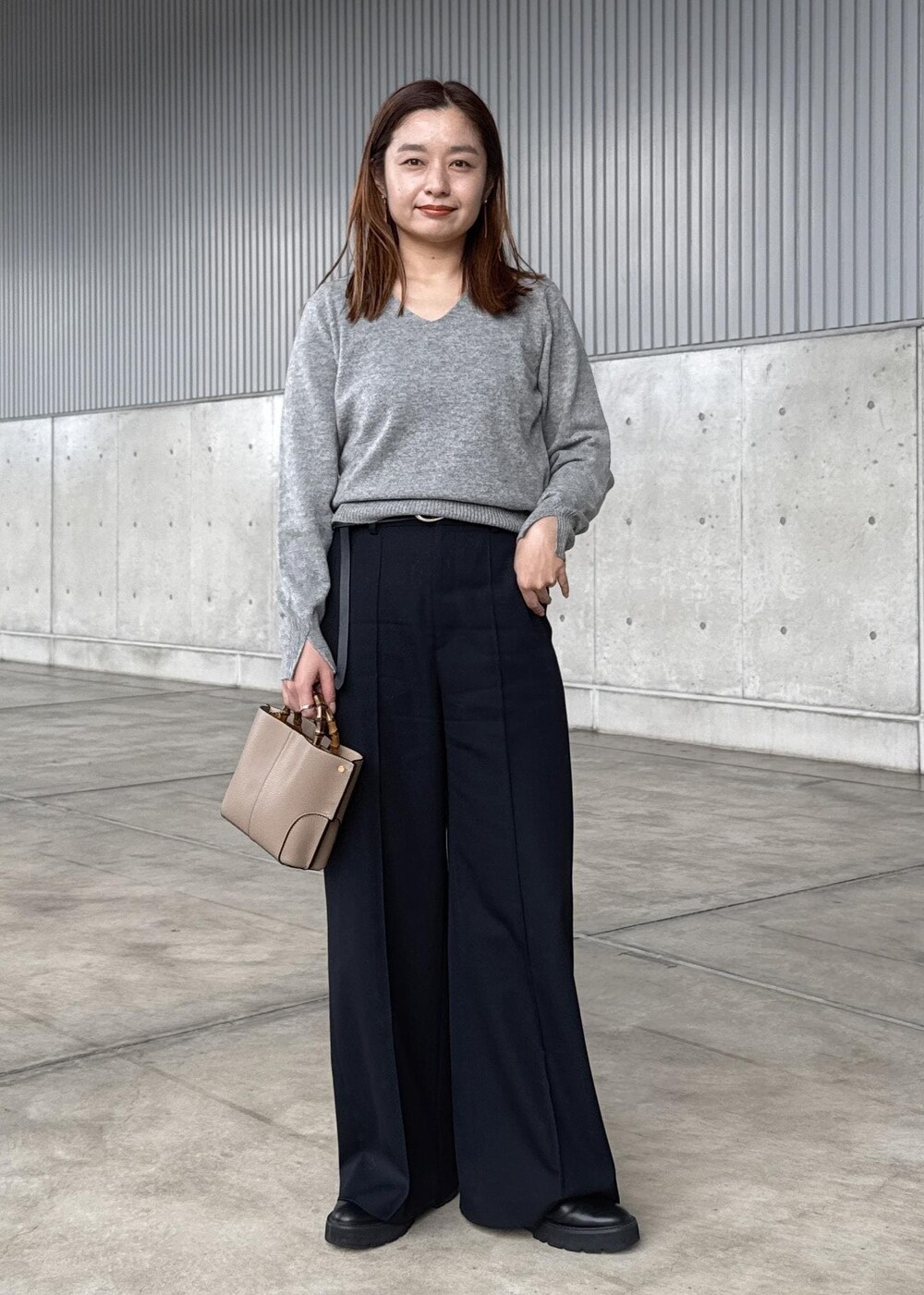 ブルー系のダウンジャケット/コート、グレー系のニット/セーター、ブラック系のその他パンツを着用したレディースの冬コーディネートの7枚目の写真