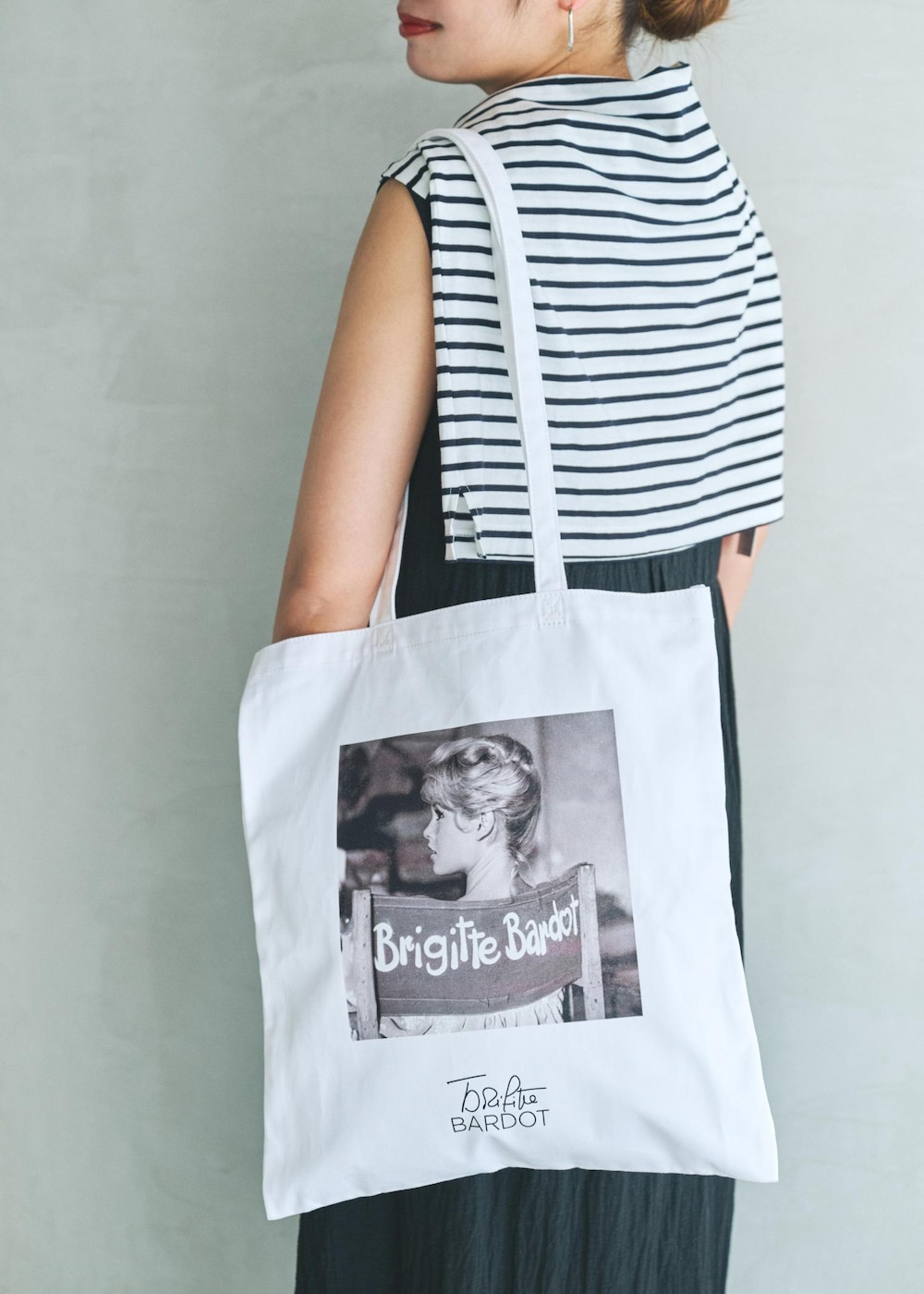 ブラック系のワンピース、ホワイト系のトートバッグを着用したレディースの夏コーディネートの5枚目の写真