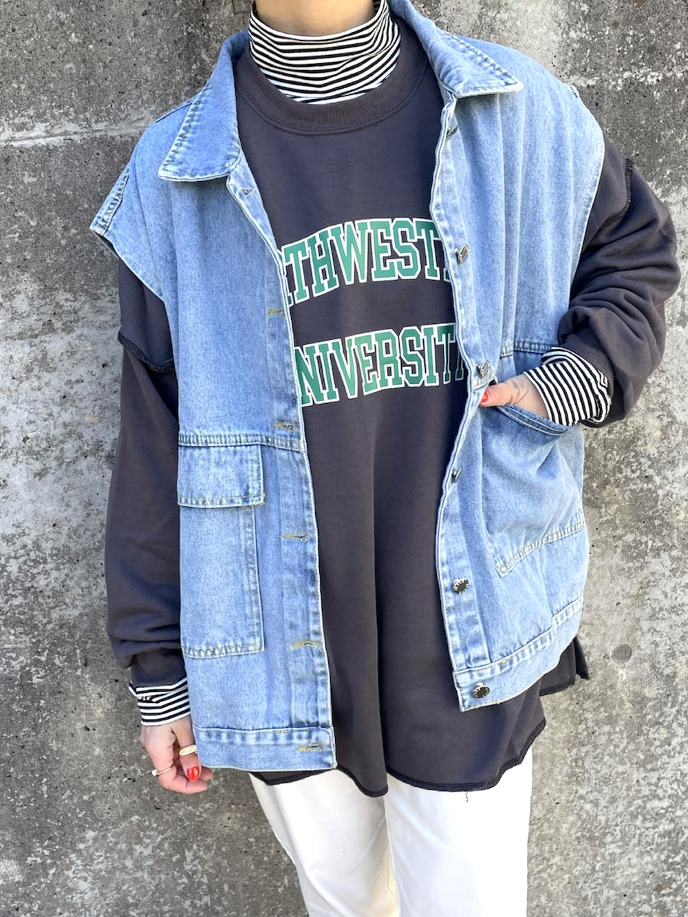 ブルー系のデニムジャケット、ブラック系のスウェット、その他のトップスを着用したレディースの春コーディネートの2枚目の写真