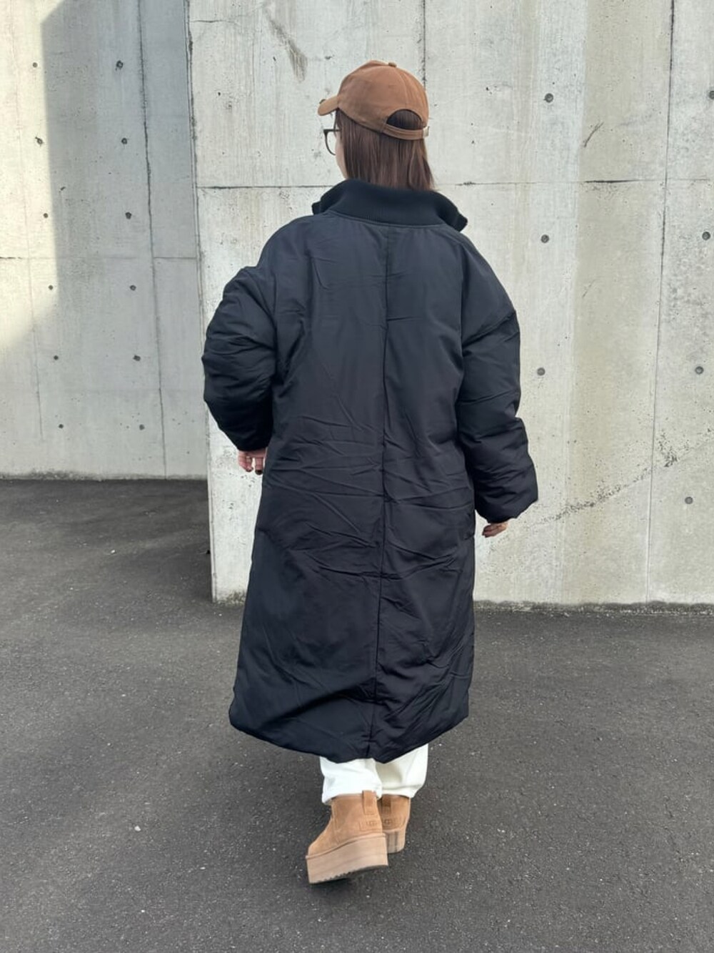 ブラック系のその他アウター、ブラック系のスウェット、ホワイト系のその他パンツを着用したレディースの冬コーディネートの4枚目の写真