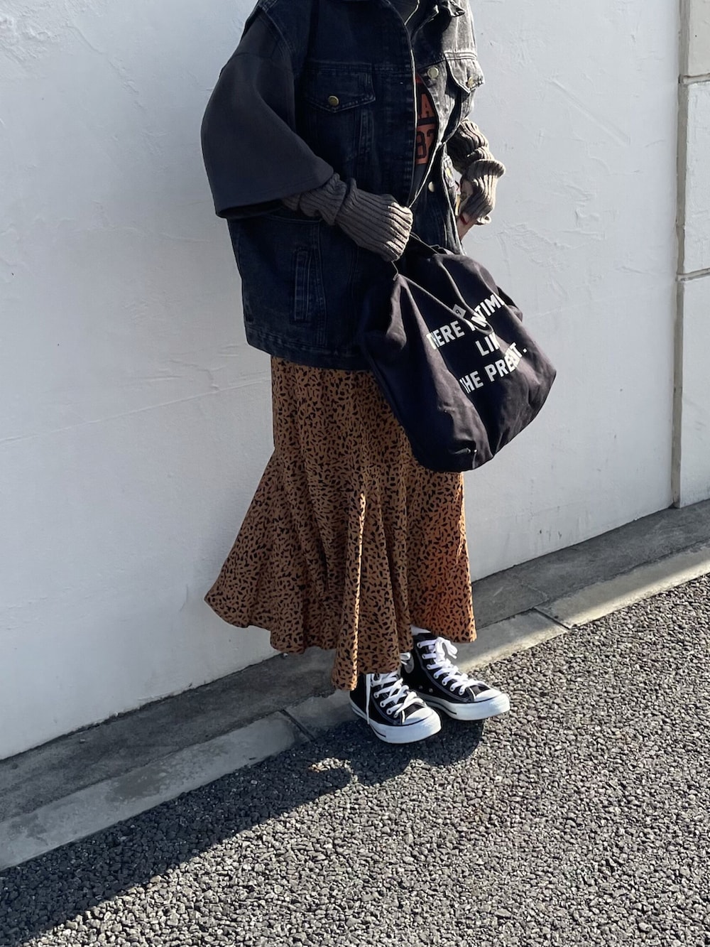 ブラック系のトップス、ブラック系のデニムジャケット、ブラウン系のスカートを着用したレディースの冬コーディネートの5枚目の写真