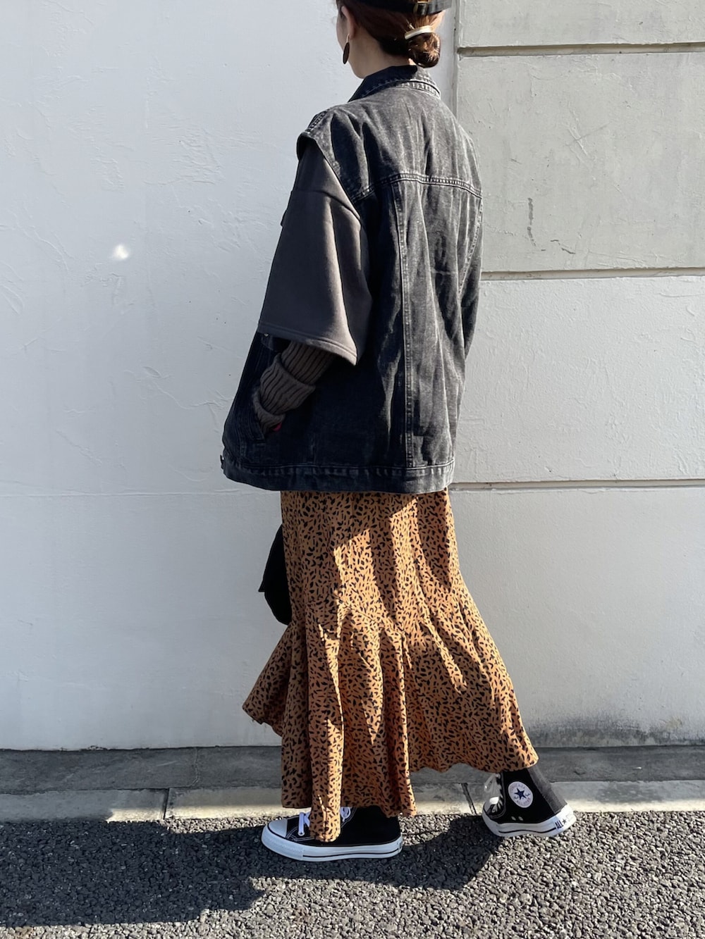 ブラック系のトップス、ブラック系のデニムジャケット、ブラウン系のスカートを着用したレディースの冬コーディネートの3枚目の写真