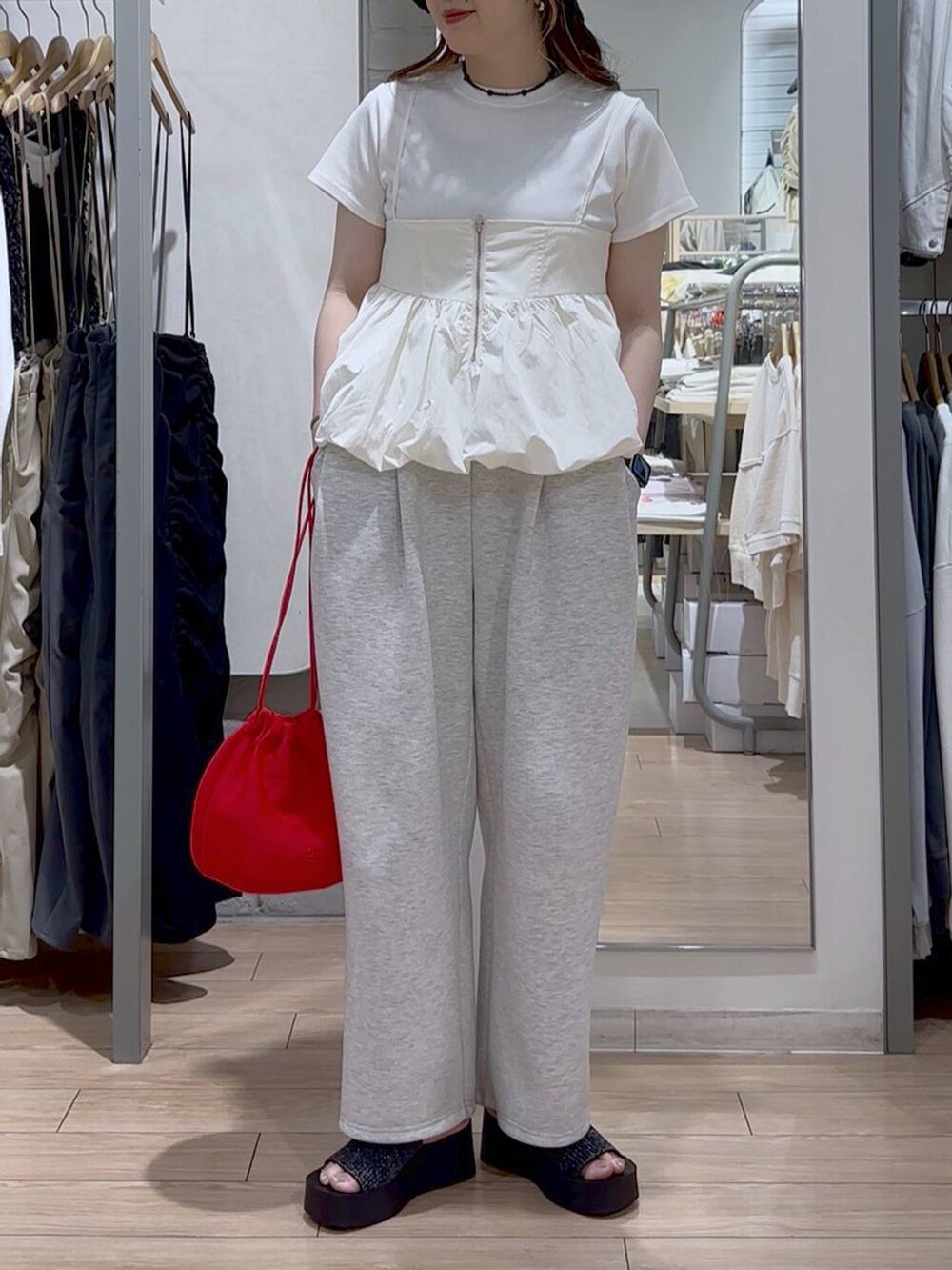 ホワイト系のTシャツ/カットソー、ブラック系のサンダル、グレー系のスウェットパンツを着用したレディースの春コーディネートの2枚目の写真