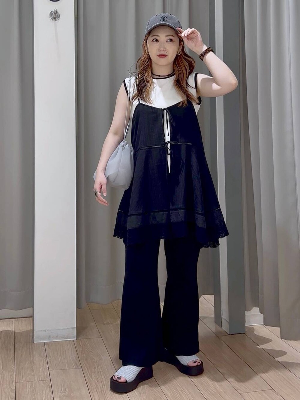 シルバー系のサンダル、グレー系のショルダーバッグ、ブラック系のワンピースを着用したレディースの秋コーディネートの6枚目の写真