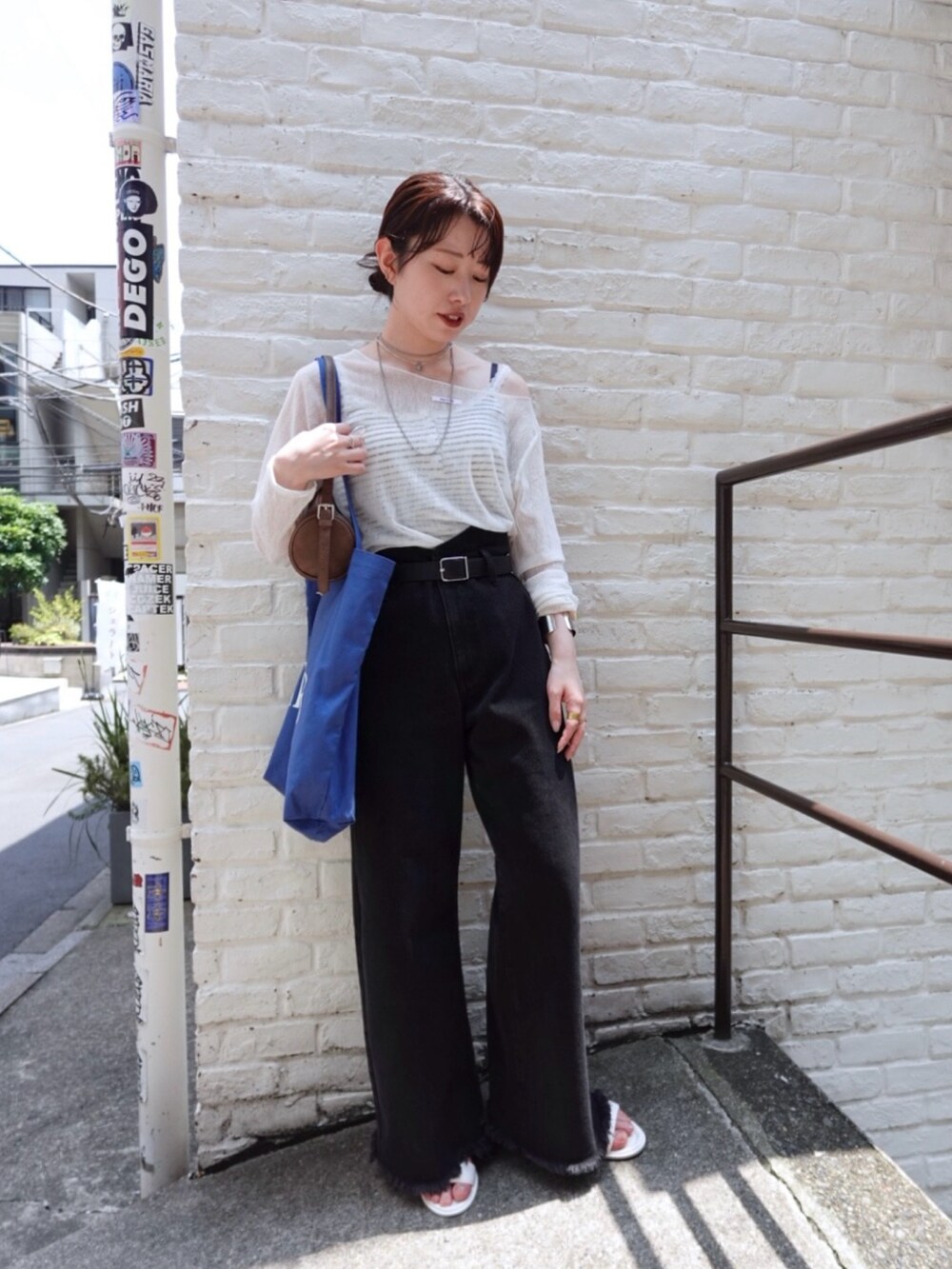 ホワイト系のTシャツ/カットソー、ブラック系のデニムパンツ、ホワイト系のキャミソールを着用したレディースの夏コーディネートの5枚目の写真