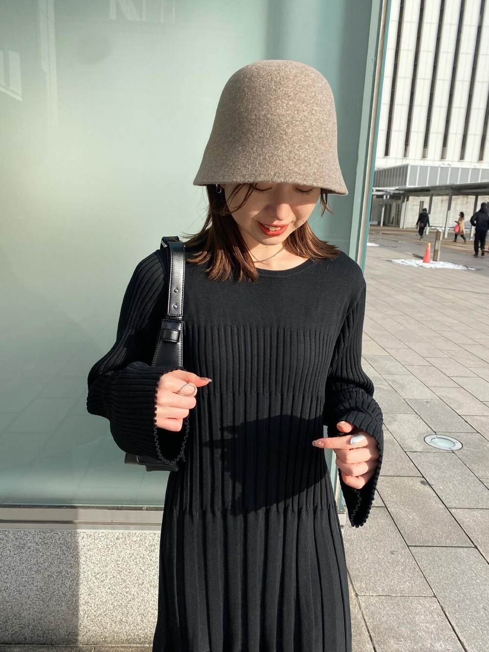 ブラック系のワンピース、ベージュ系のブーツ、ベージュ系のハットを着用したレディースの冬コーディネートの2枚目の写真