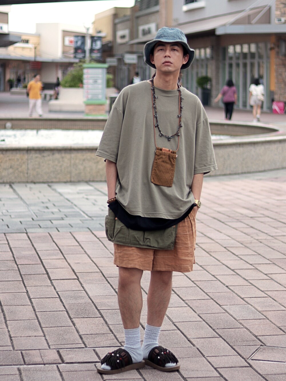 オレンジ系のカーゴパンツを着用したメンズの夏コーディネートの4枚目の写真