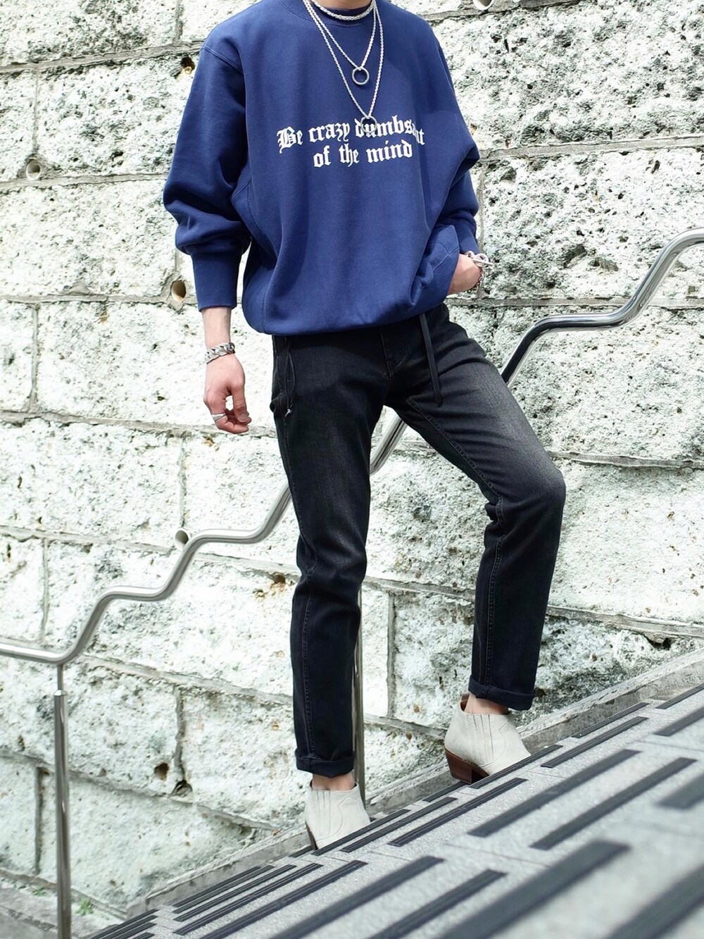 ブルー系のスウェット、ブラック系のデニムパンツを着用したメンズの春コーディネートの2枚目の写真