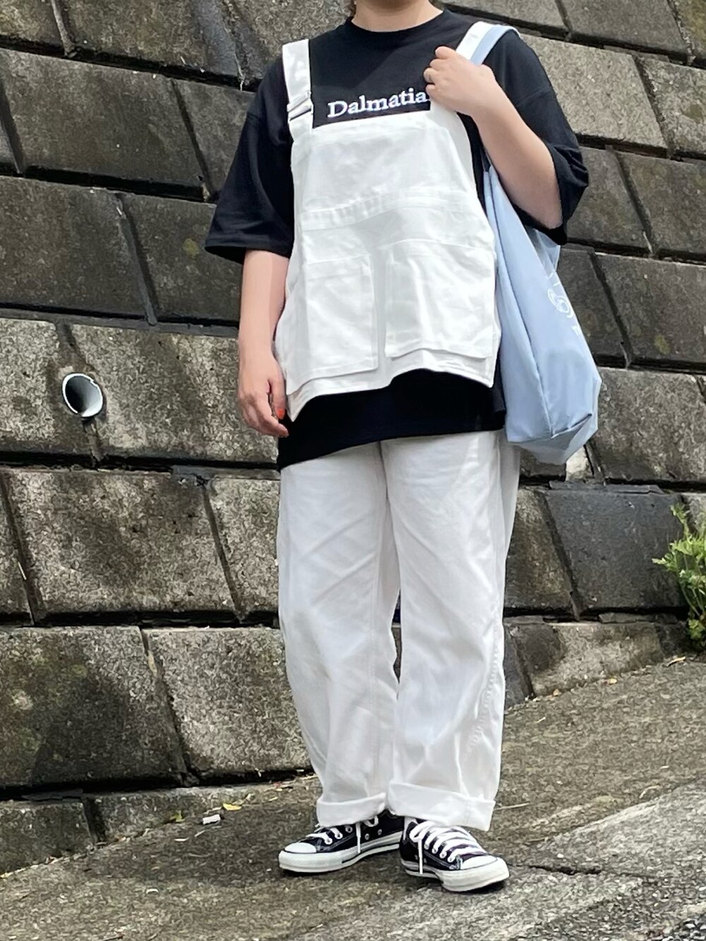 ブラック系のTシャツ/カットソー、ブラック系のスニーカーを着用したレディースの春コーディネートの2枚目の写真