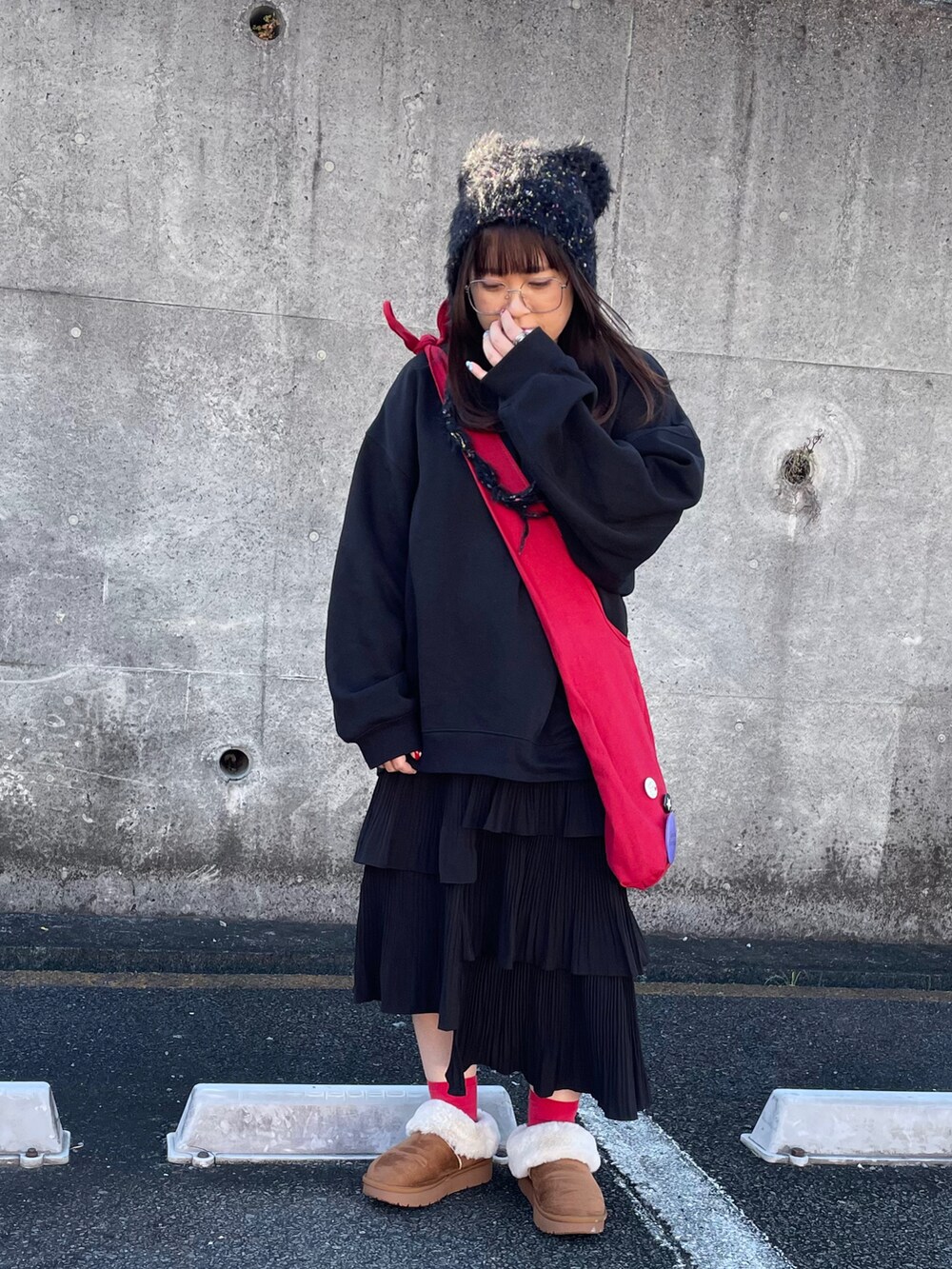 レッド系のショルダーバッグ、ベージュ系のシューズを着用したレディースの冬コーディネートの2枚目の写真