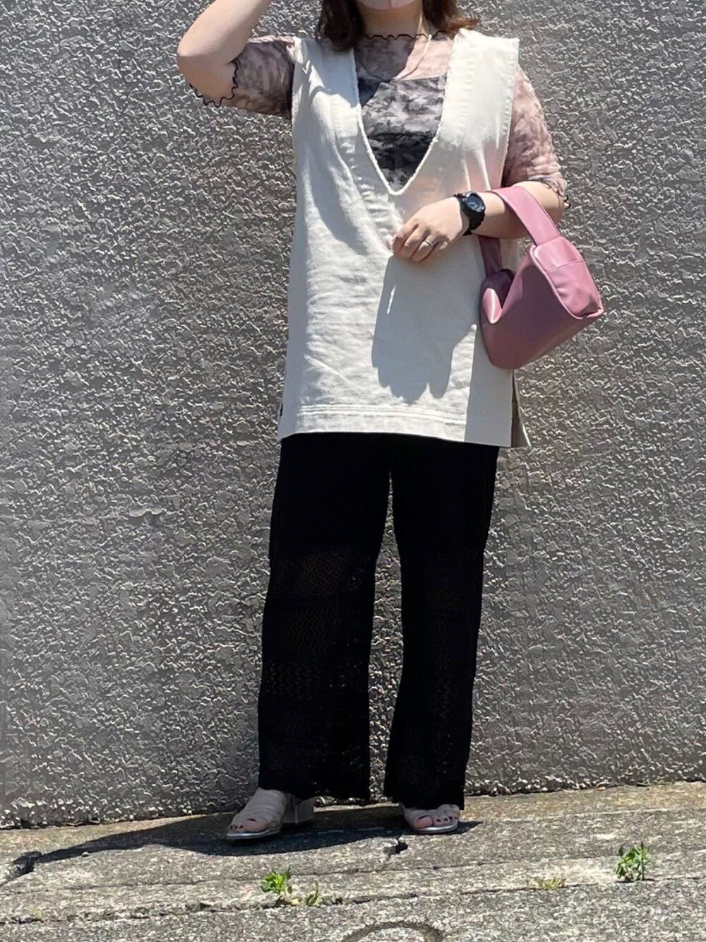 ホワイト系のベスト、ブラック系のその他パンツ、ピンク系のボストンバッグを着用したレディースの夏コーディネートの3枚目の写真