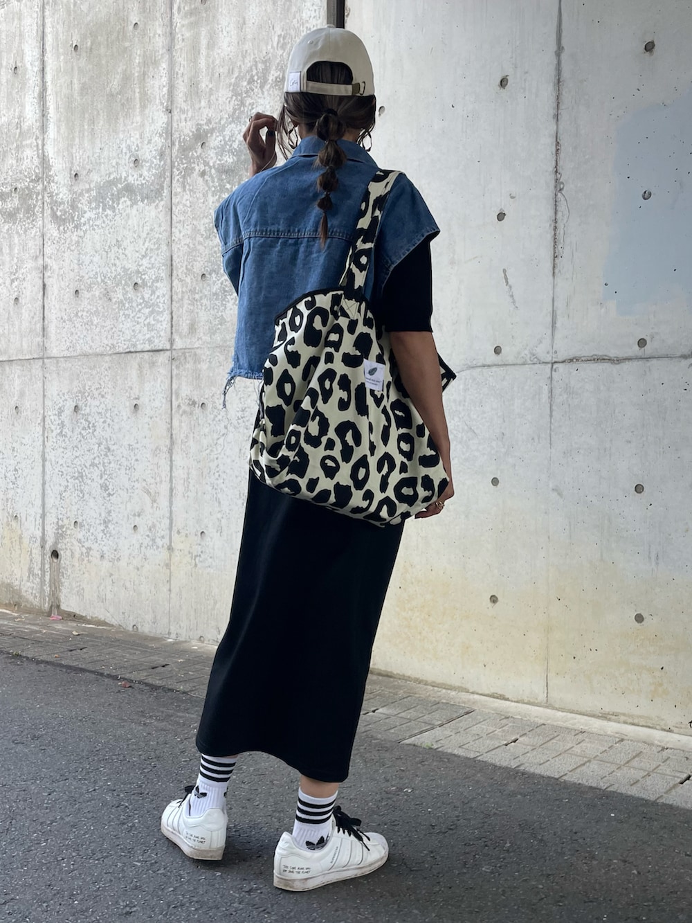 ブラック系のTシャツ/カットソー、ブルー系のベスト、ブラック系のスカートを着用したレディースの春コーディネートの3枚目の写真