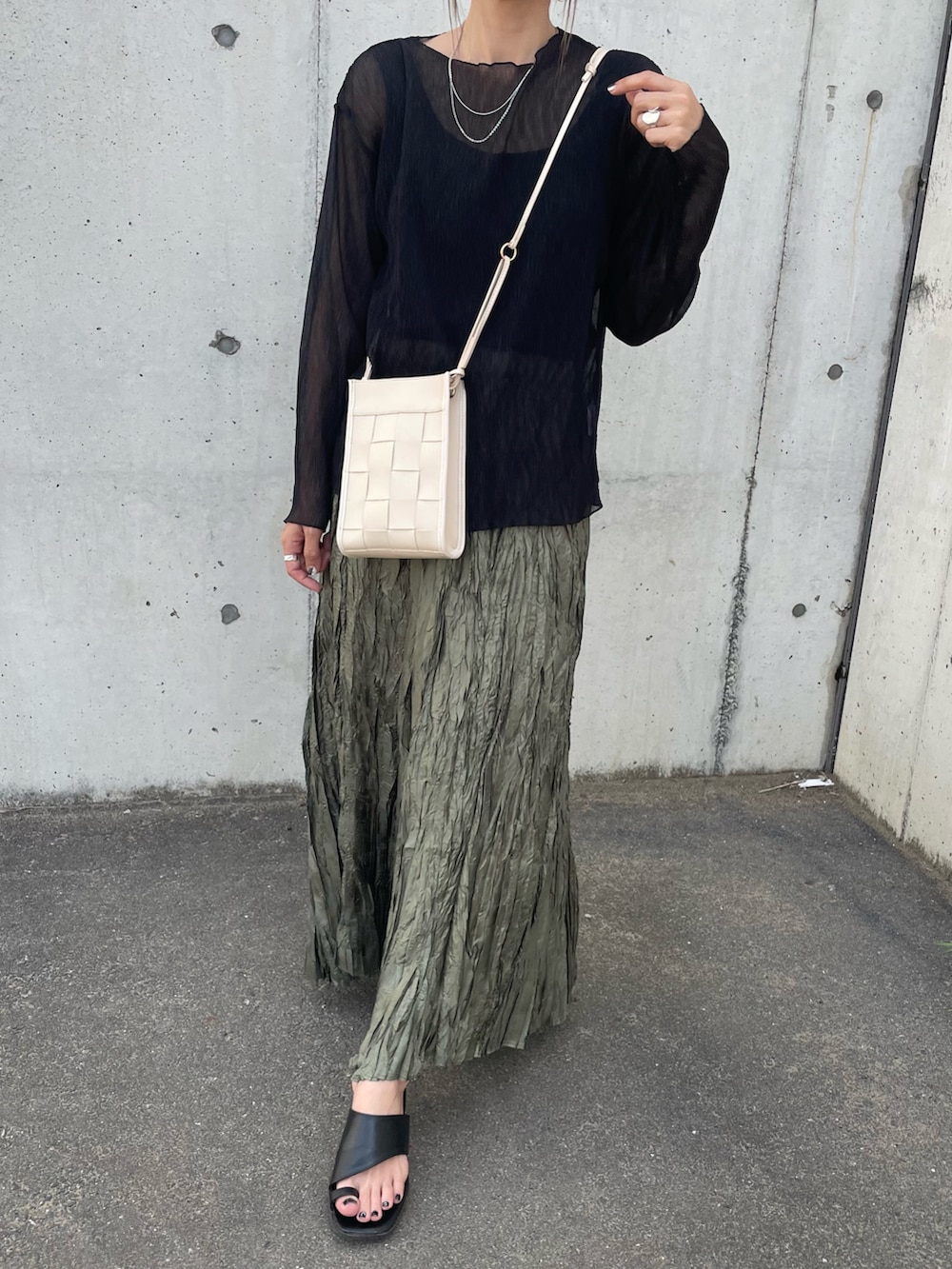 ブラック系のTシャツ/カットソー、その他のスカート、ホワイト系のショルダーバッグを着用したレディースの春コーディネートの2枚目の写真