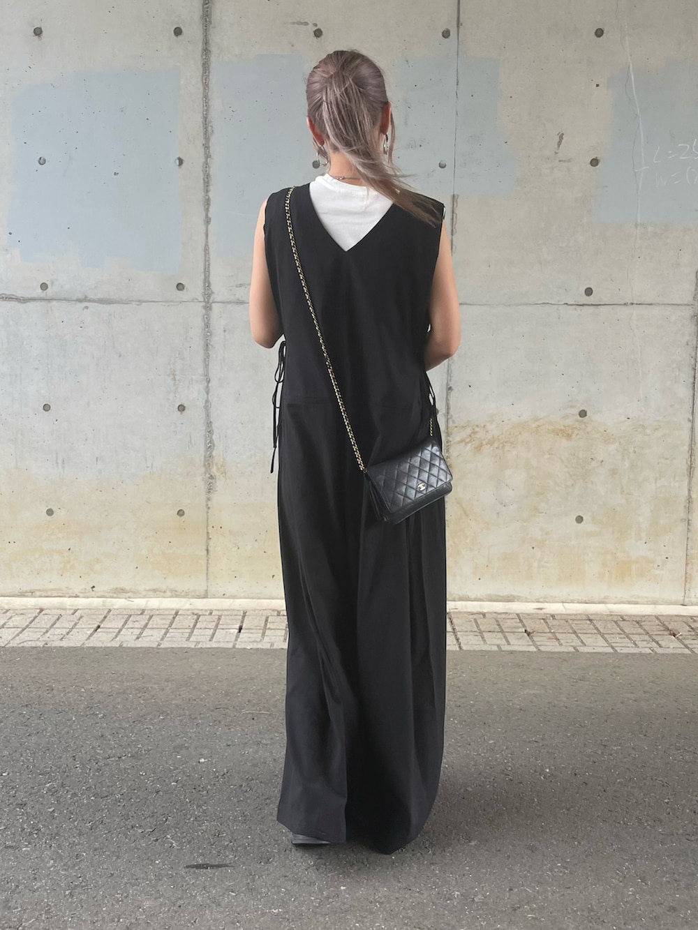 ホワイト系のTシャツ/カットソー、ブラック系のつなぎ/オールインワン、ブラック系のサンダルを着用したレディースの夏コーディネートの3枚目の写真