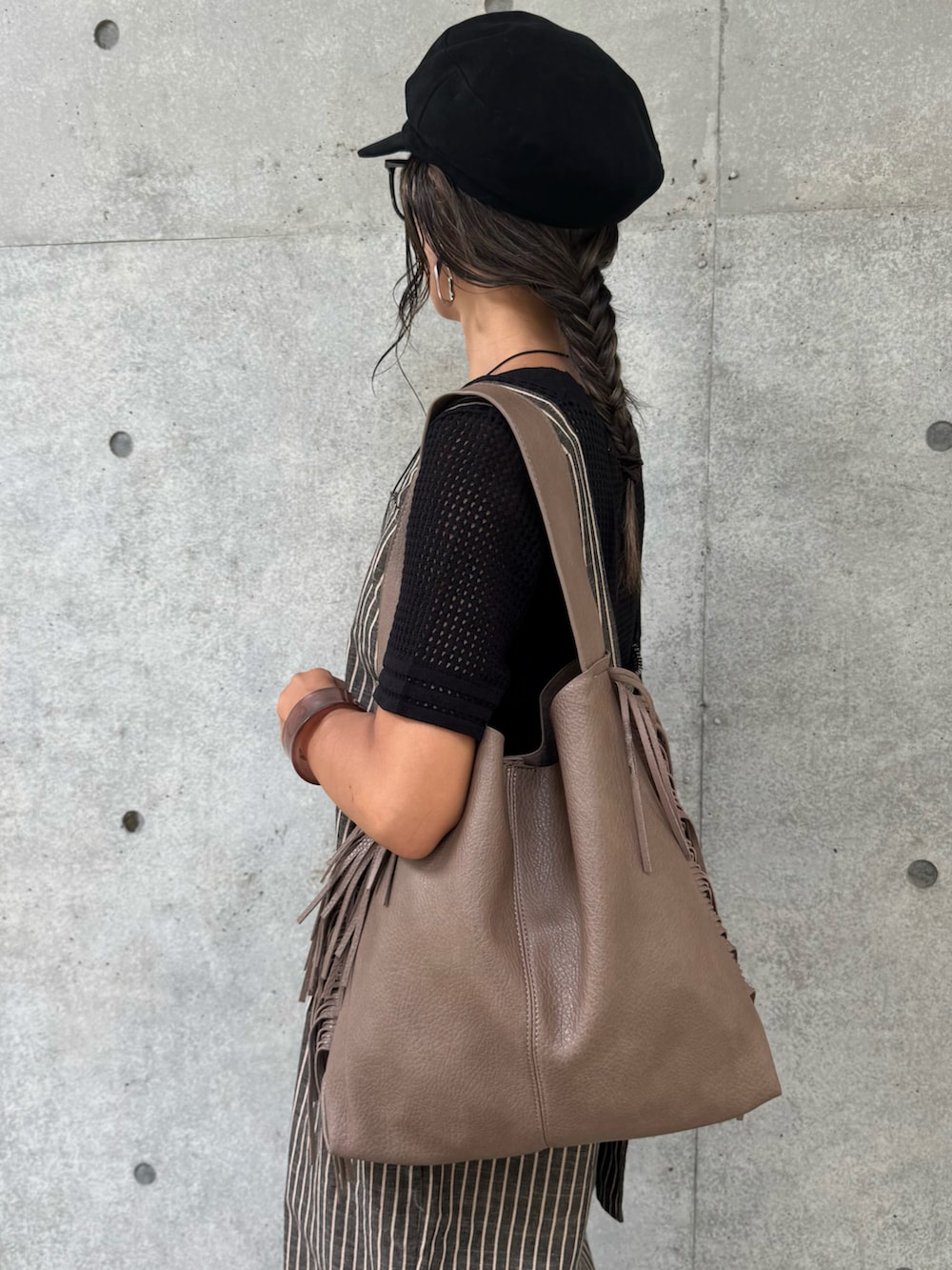 ブラック系のTシャツ/カットソー、ブラック系のサロペット/オーバーオール、ベージュ系のショルダーバッグを着用したレディースの秋コーディネートの4枚目の写真