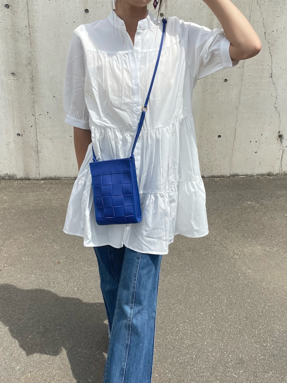 ホワイト系のシャツ/ブラウス、ブルー系のデニムパンツ、ブルー系のショルダーバッグを着用したレディースの春コーディネートの3枚目の写真