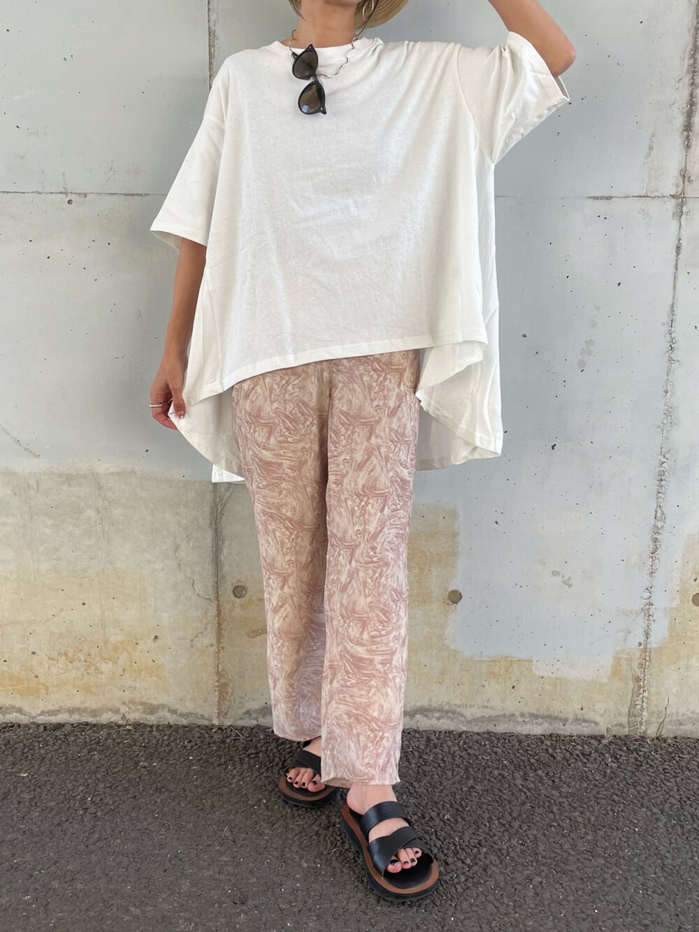 ホワイト系のTシャツ/カットソー、オレンジ系のその他パンツ、ブラック系のサンダルを着用したレディースの春コーディネートの2枚目の写真