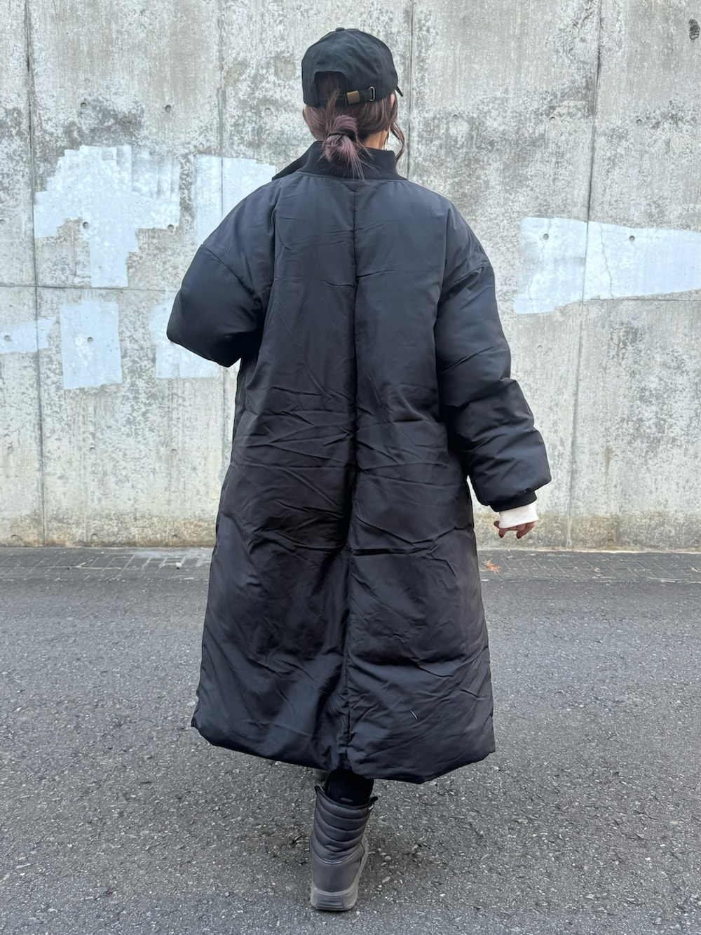 ブラック系のその他アウター、ホワイト系のスウェット、ブラック系のその他パンツを着用したレディースの冬コーディネートの4枚目の写真