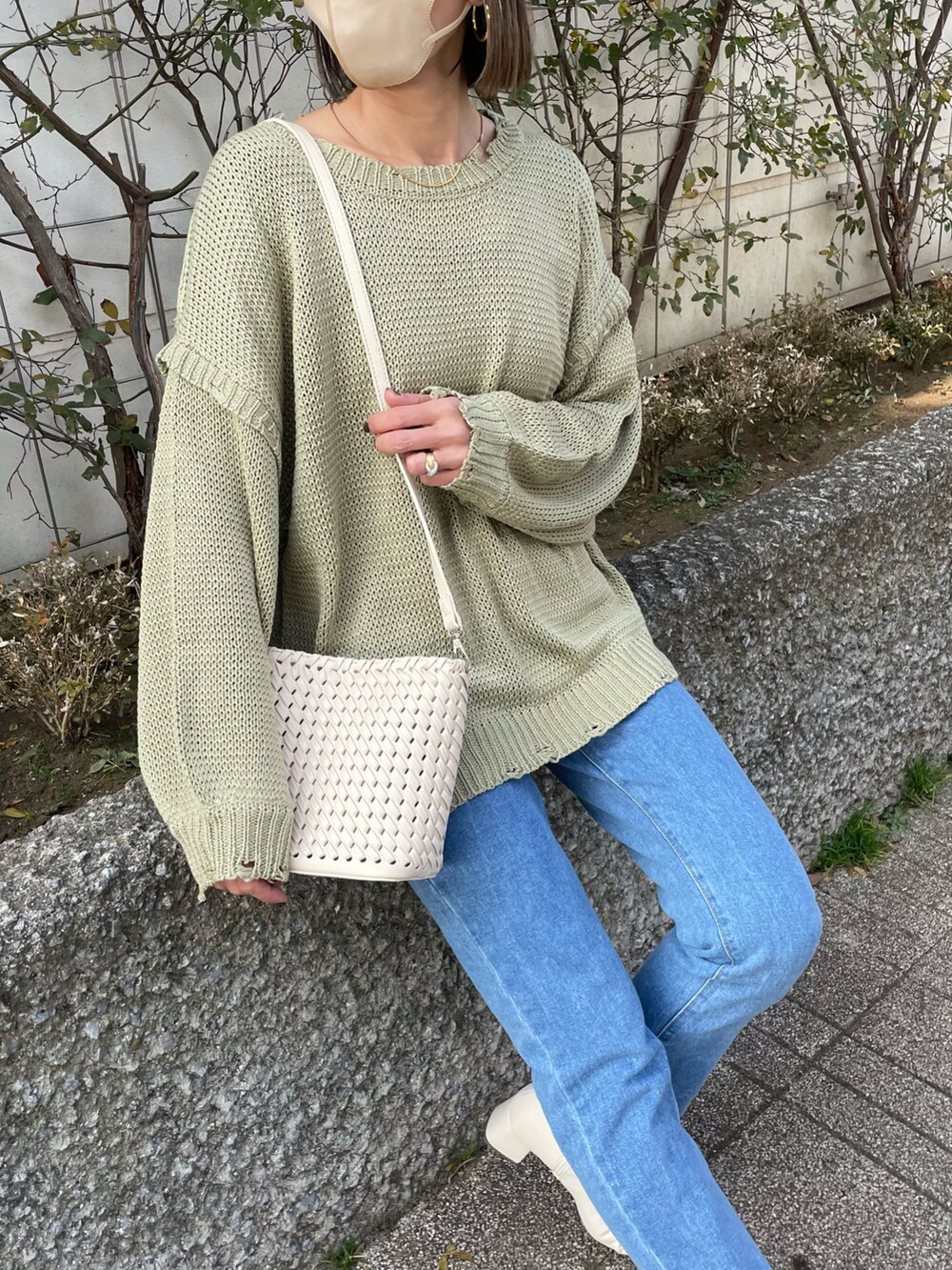 ホワイト系のその他アウター、ベージュ系のショルダーバッグ、ホワイト系のブーツを着用したレディースの冬コーディネートの4枚目の写真