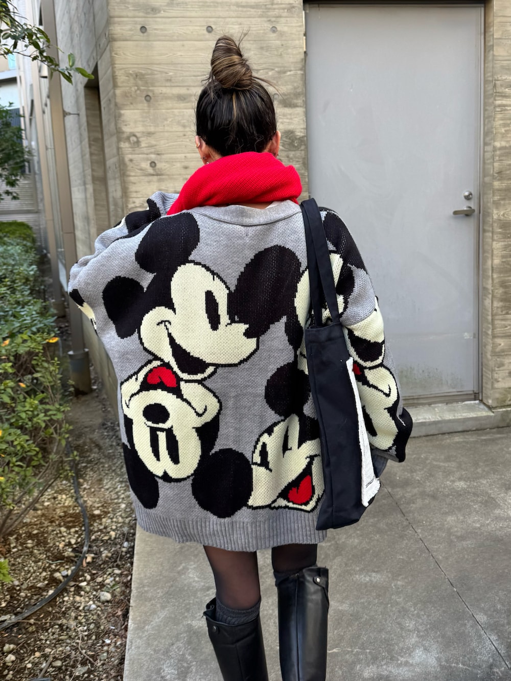 ブラック系のトートバッグ、グレー系のカーディガン/ボレロ、ブラック系のブーツを着用したレディースの冬コーディネートの2枚目の写真