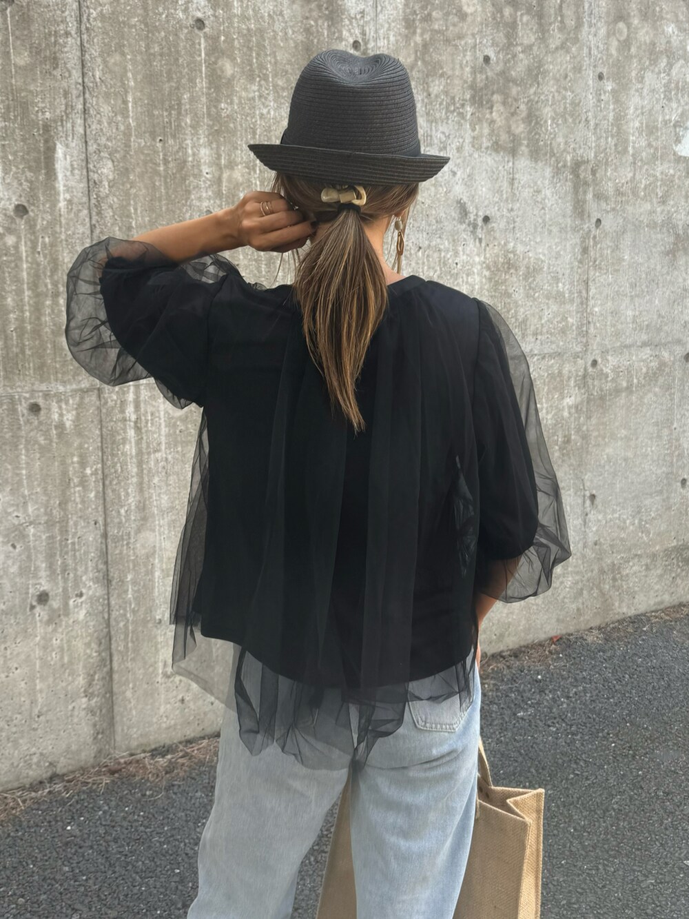 ブラック系のTシャツ/カットソー、ブルー系のデニムパンツ、ピンク系のトートバッグを着用したレディースの夏コーディネートの4枚目の写真