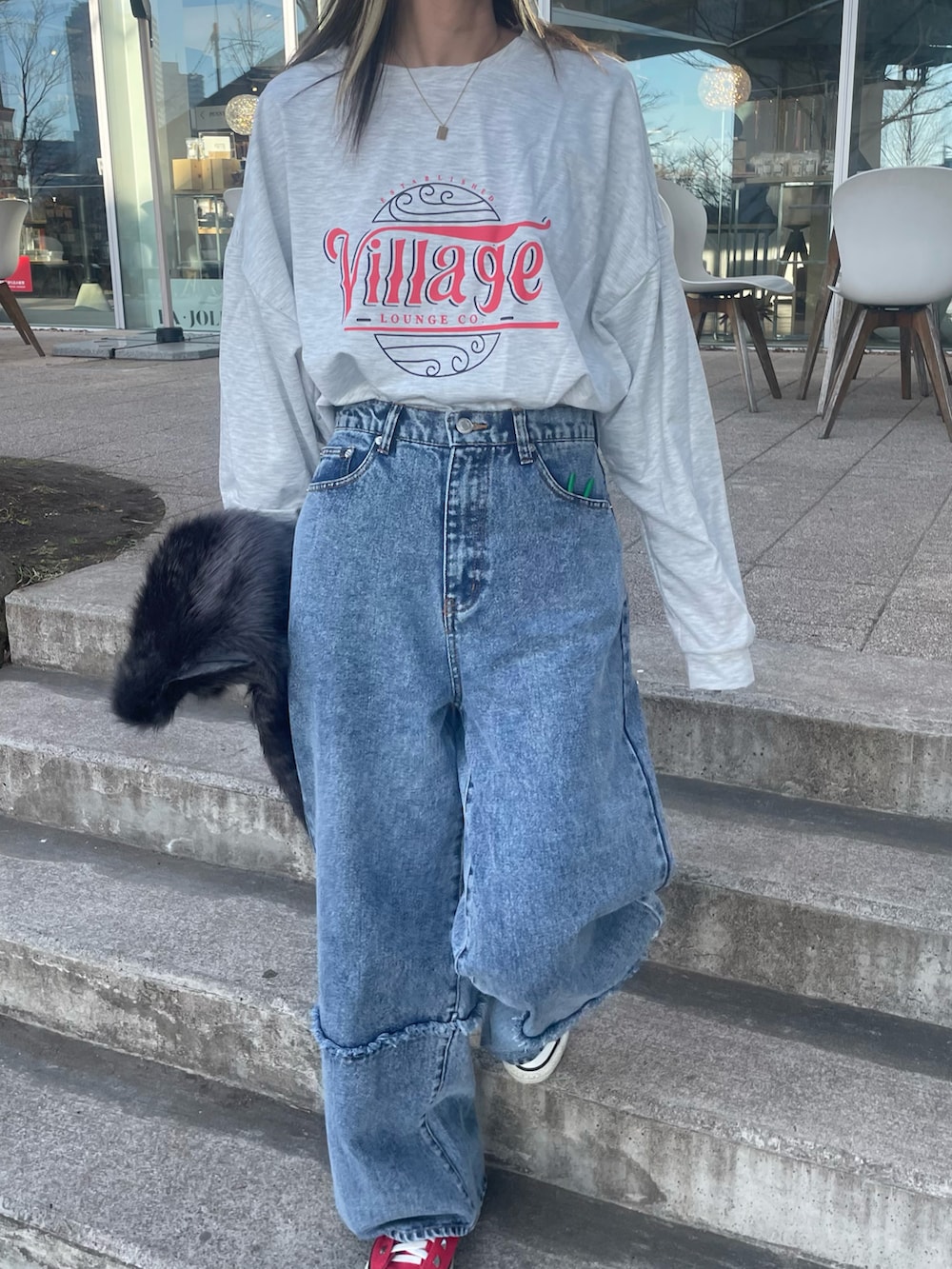 ホワイト系のTシャツ/カットソー、グレー系のベスト、ブルー系のデニムパンツを着用したレディースの冬コーディネートの4枚目の写真