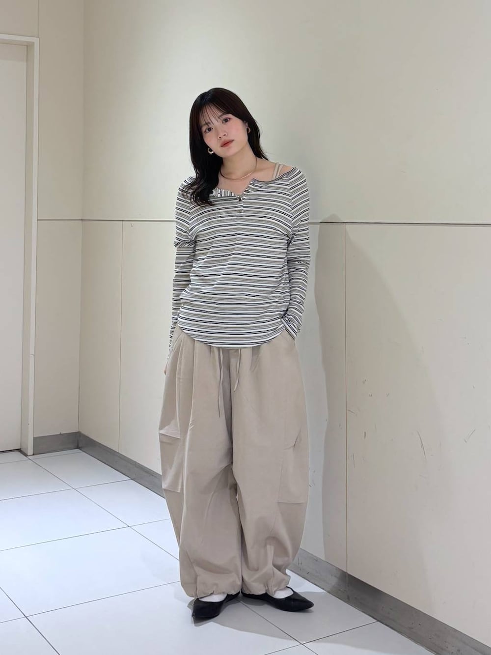 ホワイト系のTシャツ/カットソー、ブラック系のショルダーバッグ、ベージュ系のその他パンツを着用したレディースの春コーディネートの3枚目の写真
